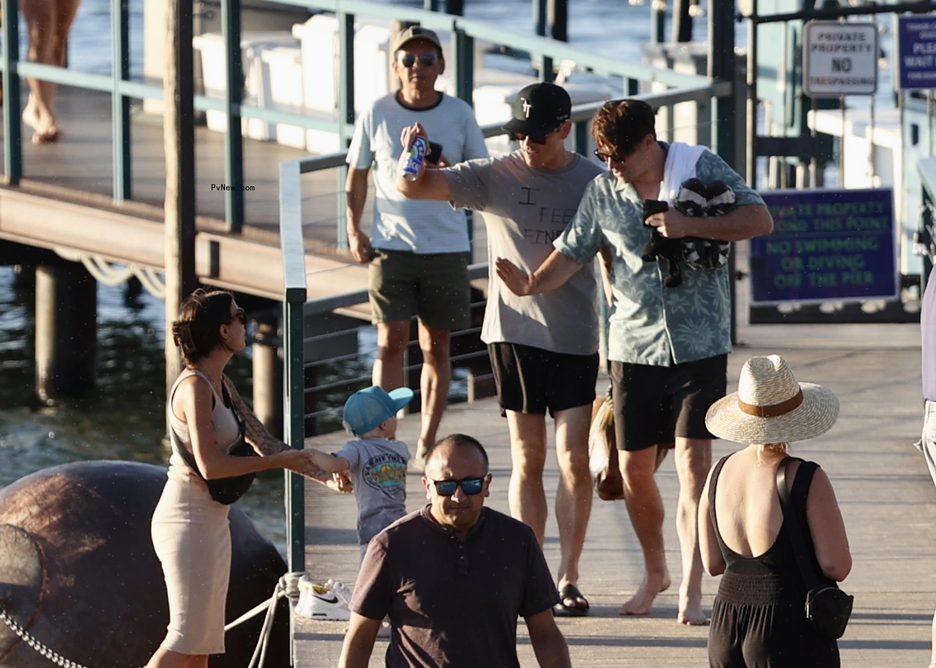 Tom Schwartz and Tom Sandoval walking on a boardwalk