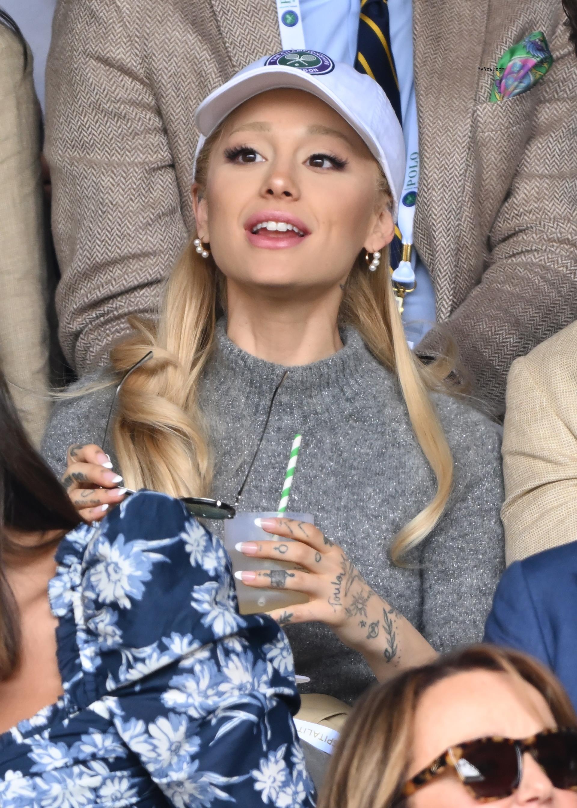 Ariana Grande sitting at Wimbledon 