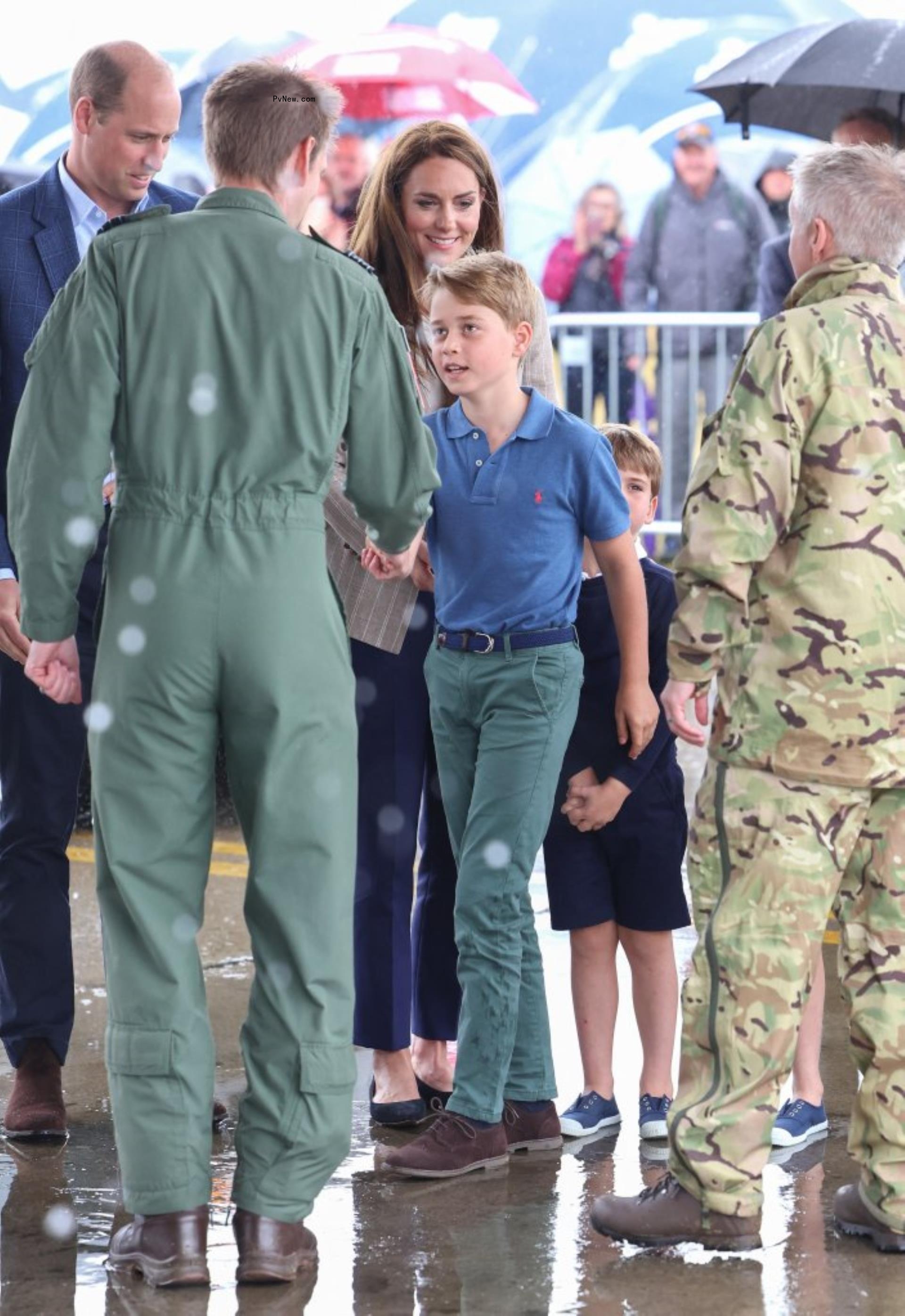 Prince George shaking someone's hand.