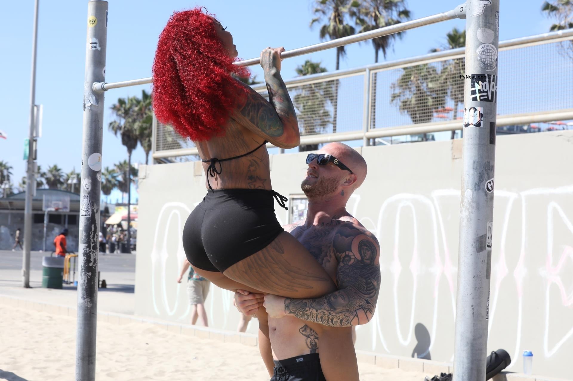 Chet Hanks and Melissa Maysing working out on the beach.