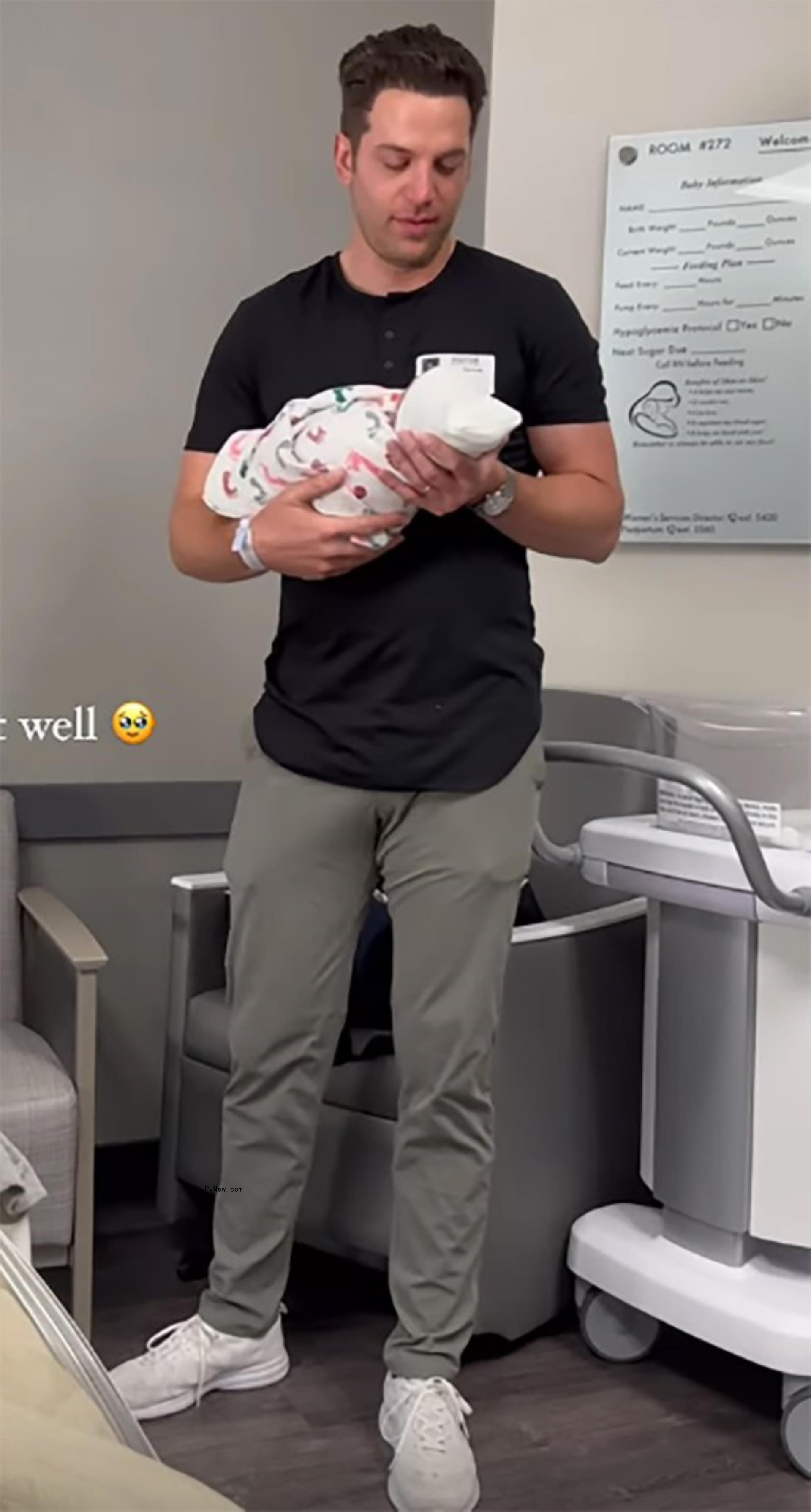 Adam Gottschalk holding newborn baby