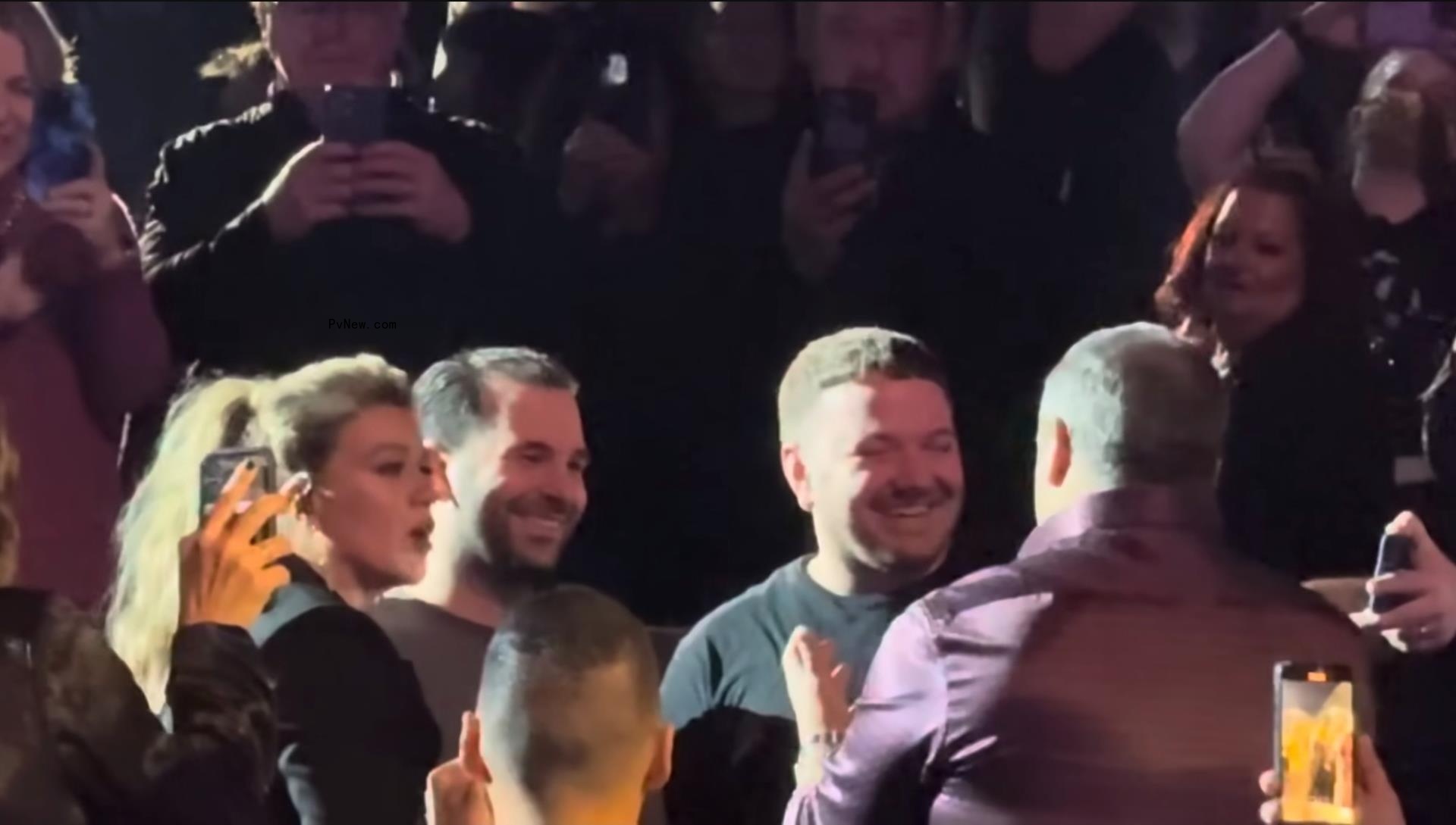 Brian Artzt and Marcello Cialini with Kelly Clarkson and an officiant.