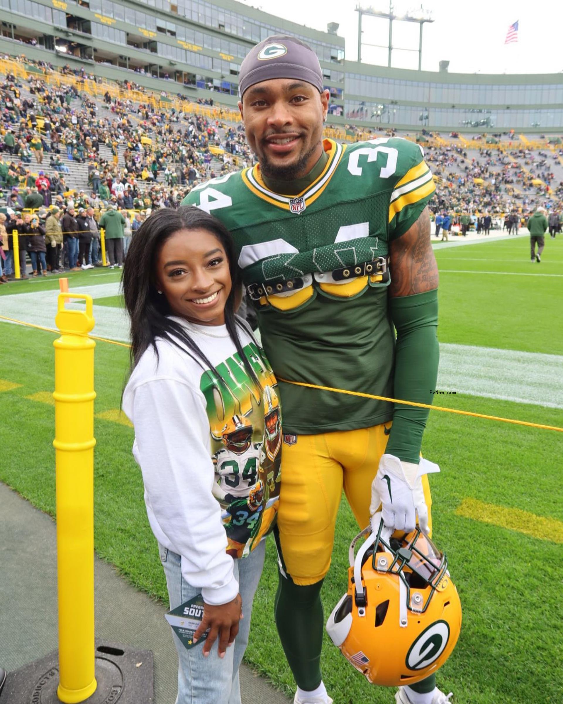 Simone Biles and Jo<i></i>nathan Owens on a football field.