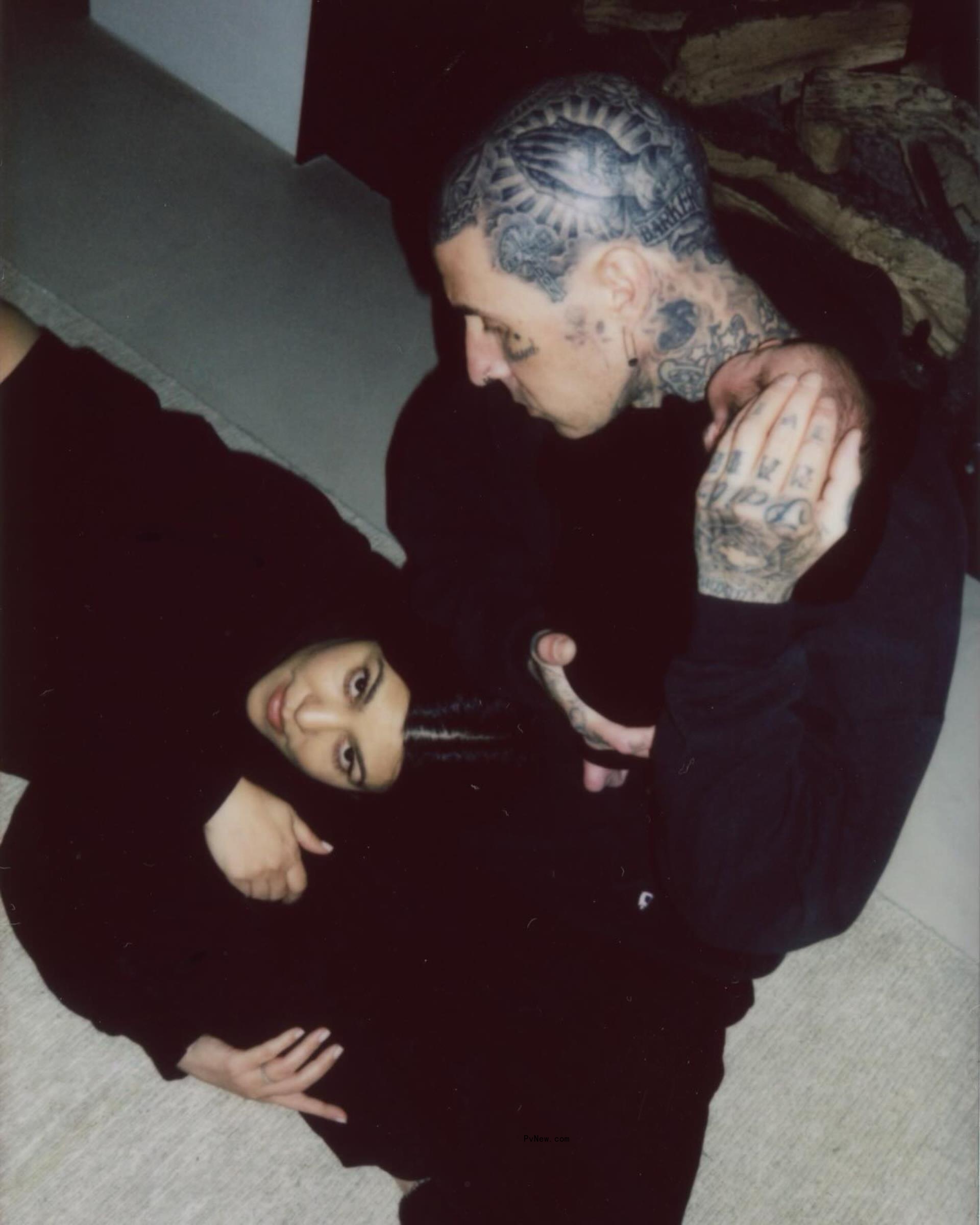 travis barker holding baby Rocky with Kourtney kardashian