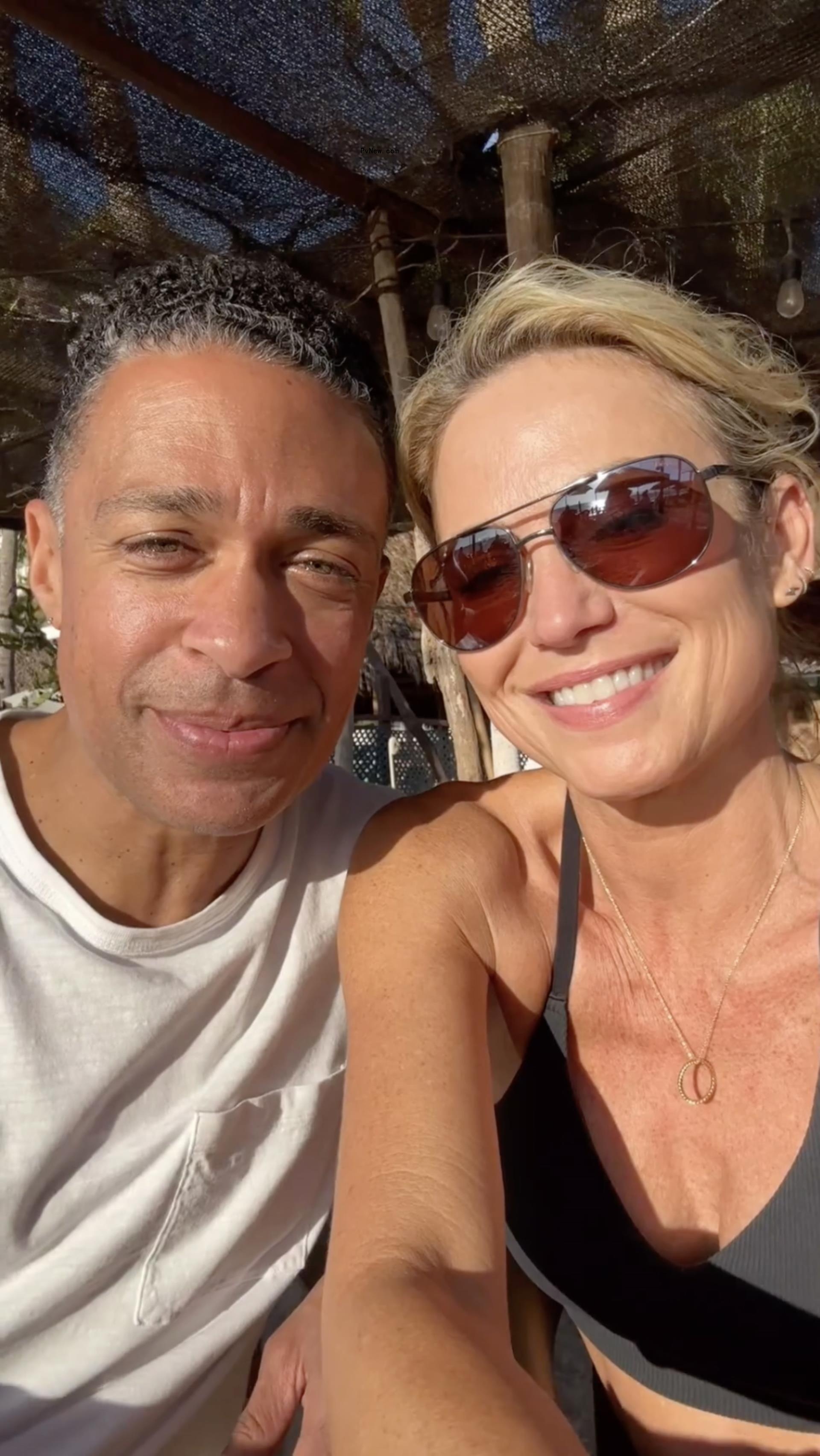 A selfie of TJ Holmes and Amy Robach