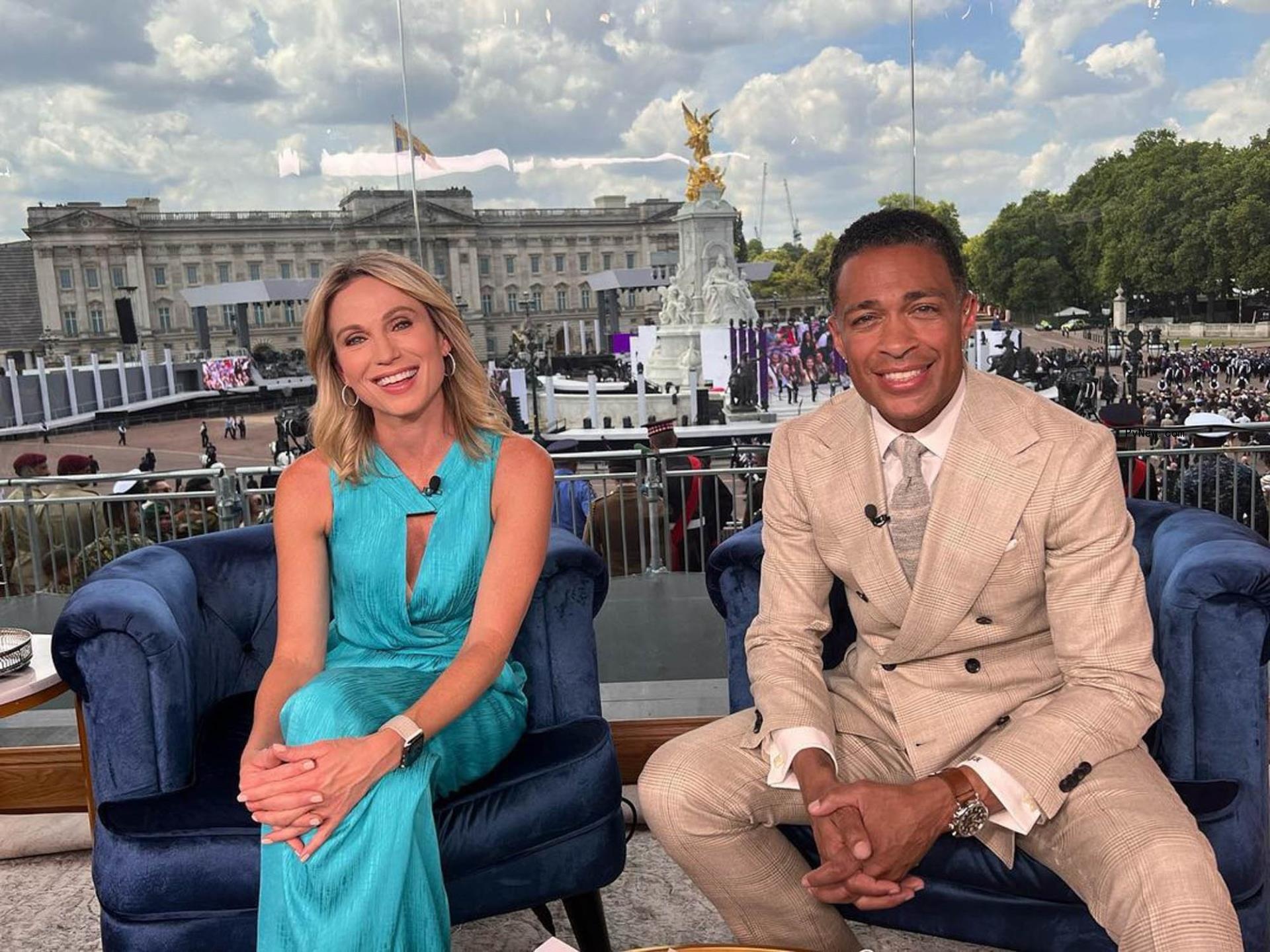 Amy Robach and TJ Holmes sitting