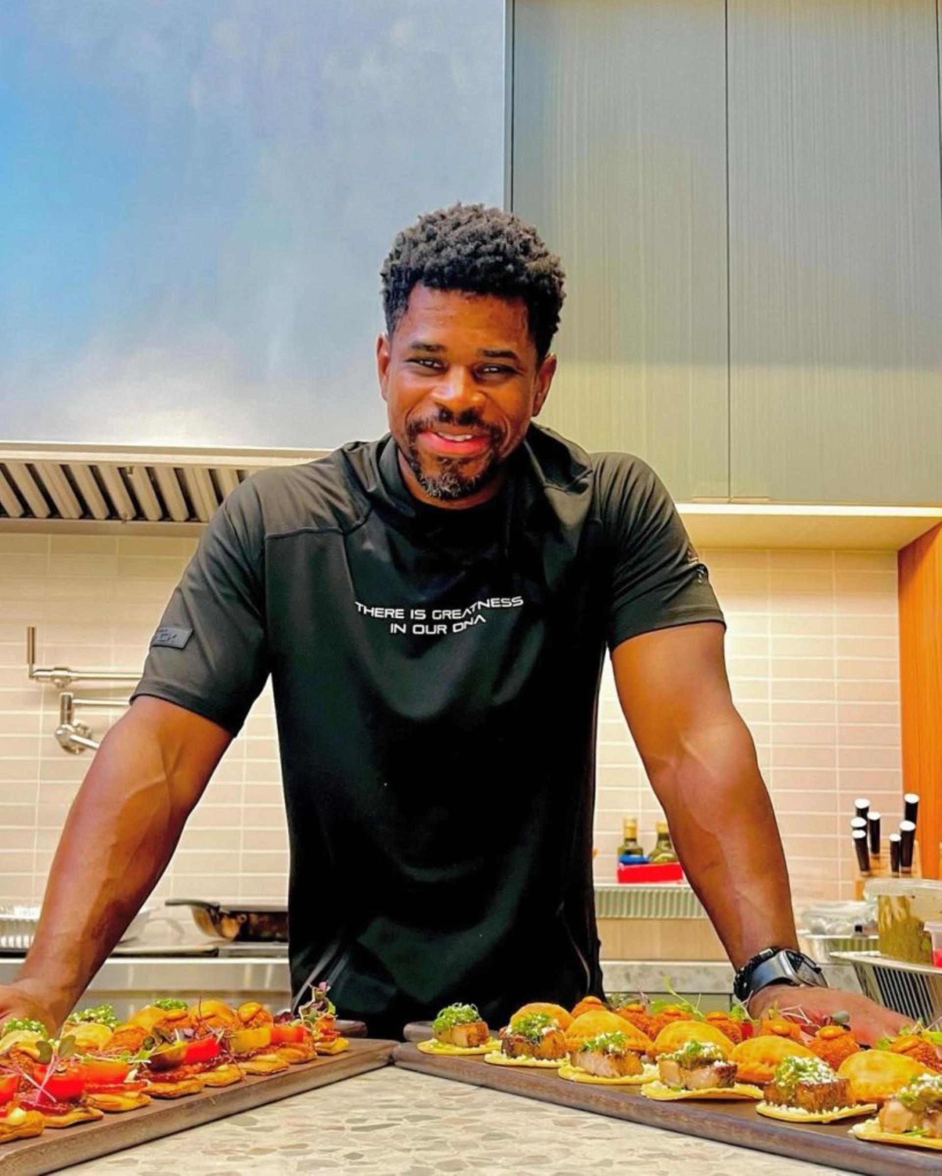 tafari campbell leaning over food in a kitchen