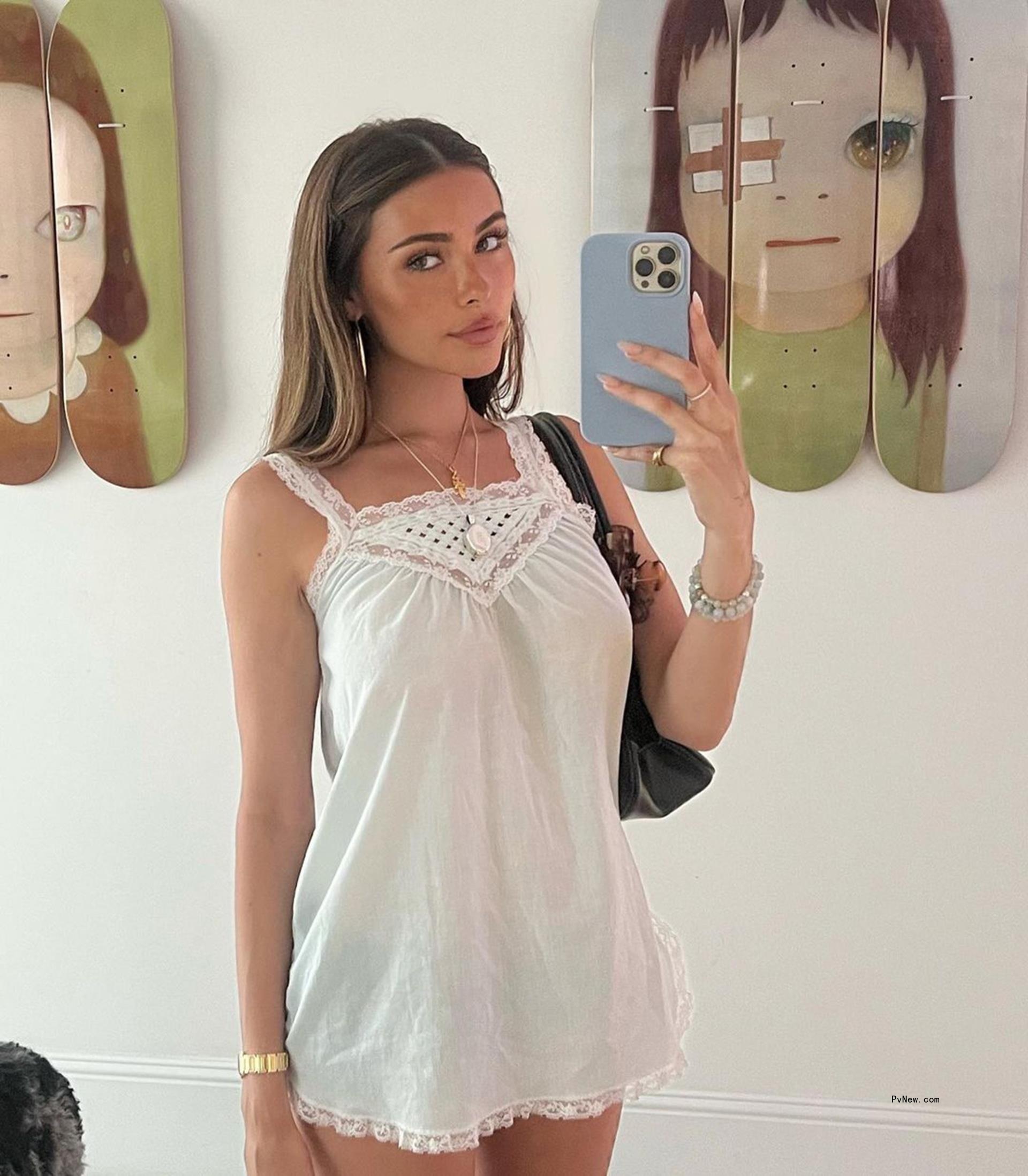 madison beer taking mirror selfie in a white dress