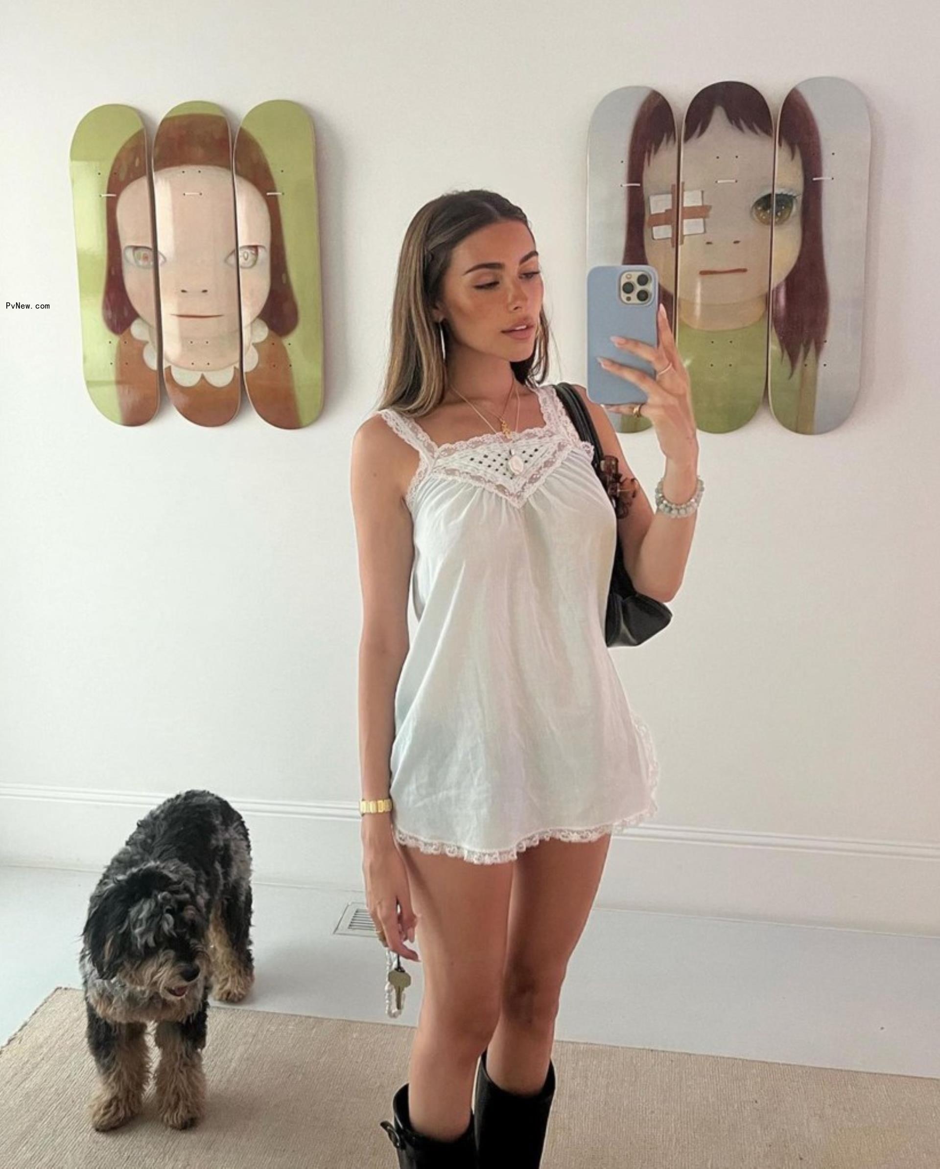 madison beer taking a mirror selfie with her dog next to her