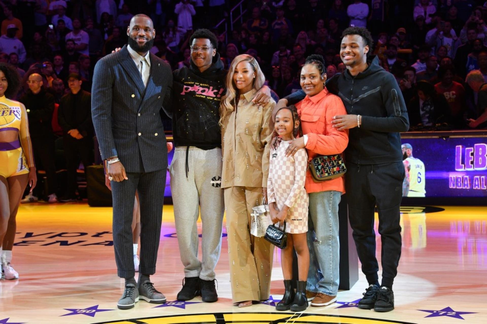 lebron james and his family posing together on a basketball court