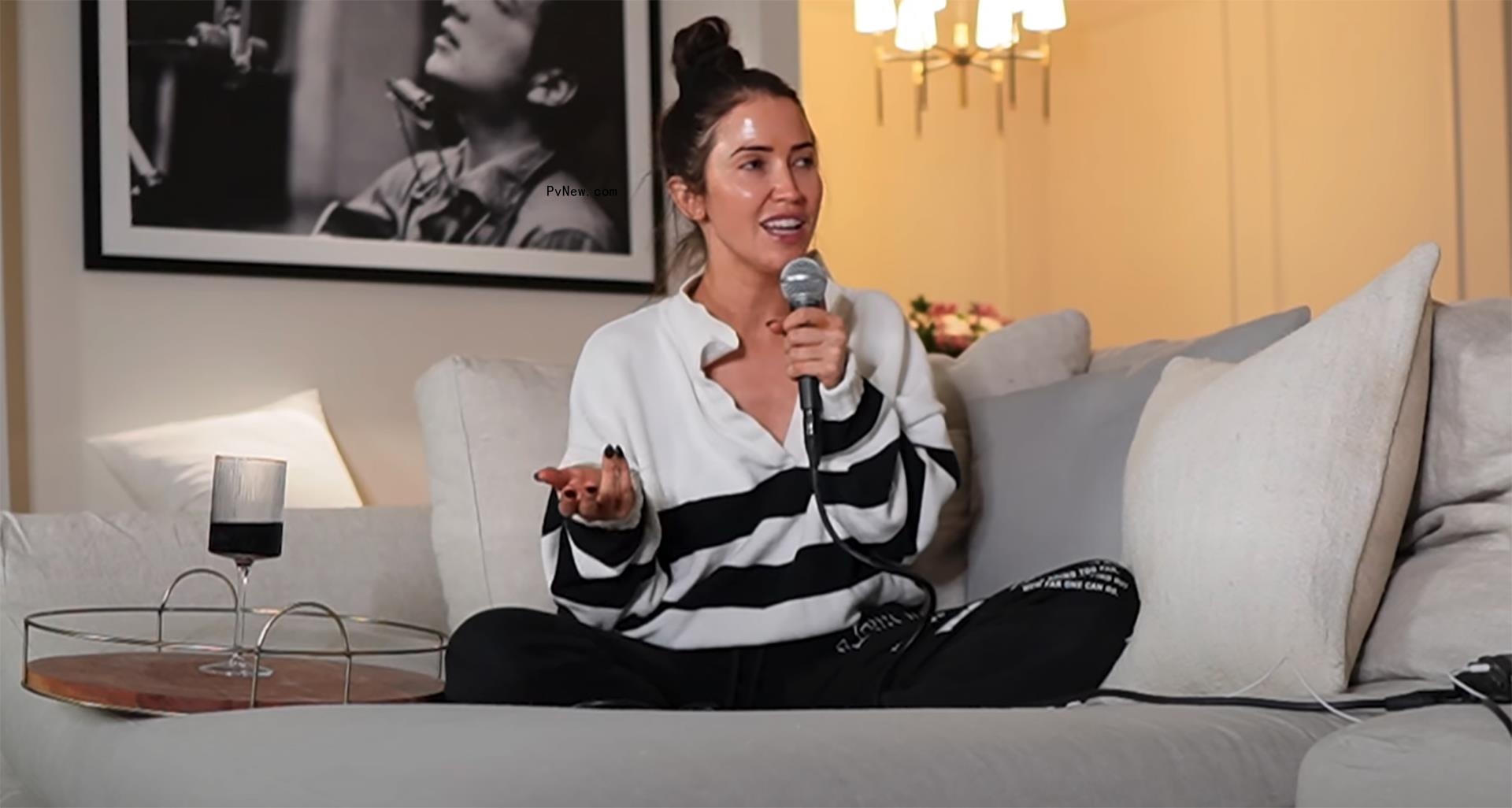Kaitlyn Bristowe holding a mic.