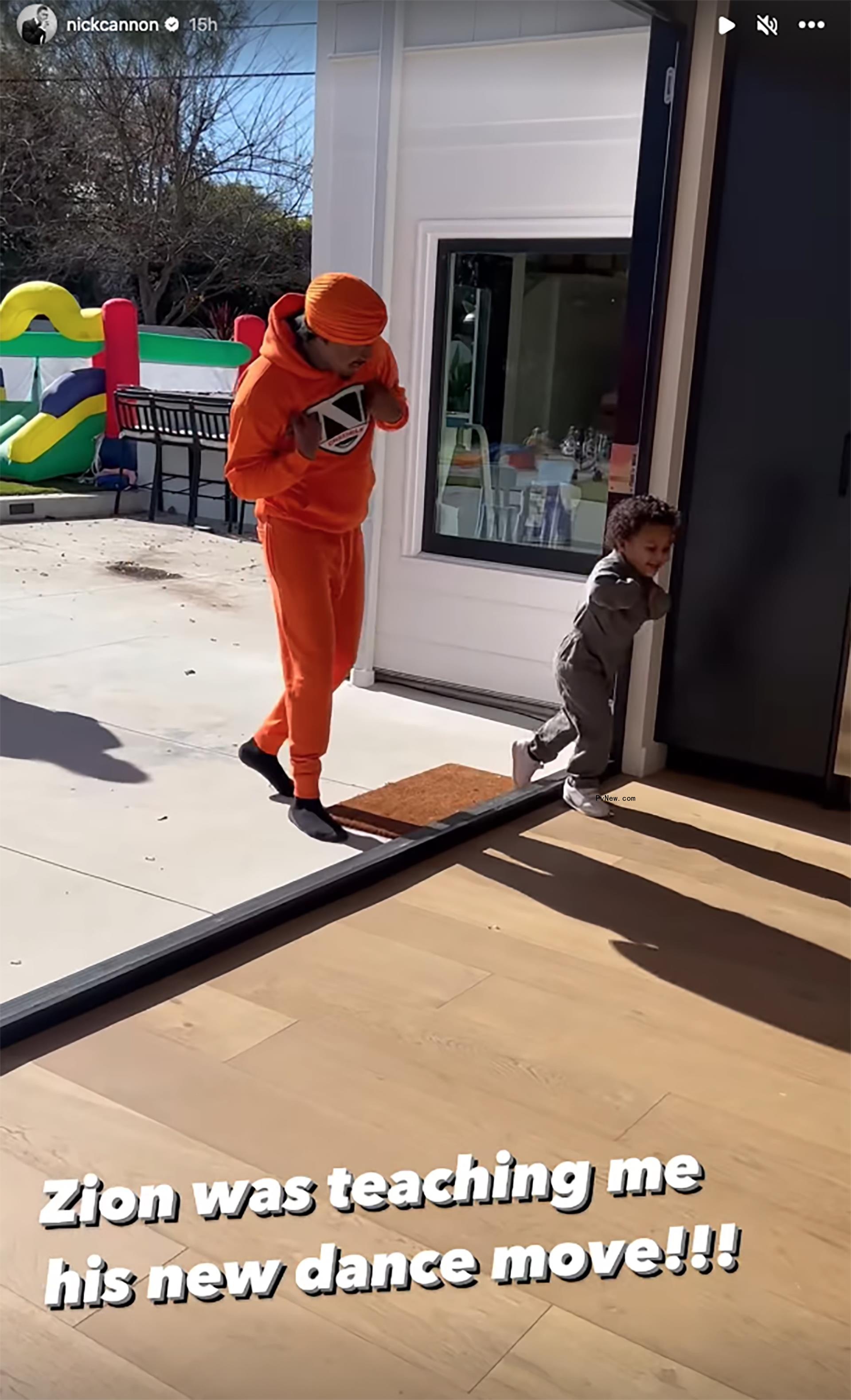 Nick Cannon dancing with one of his sons