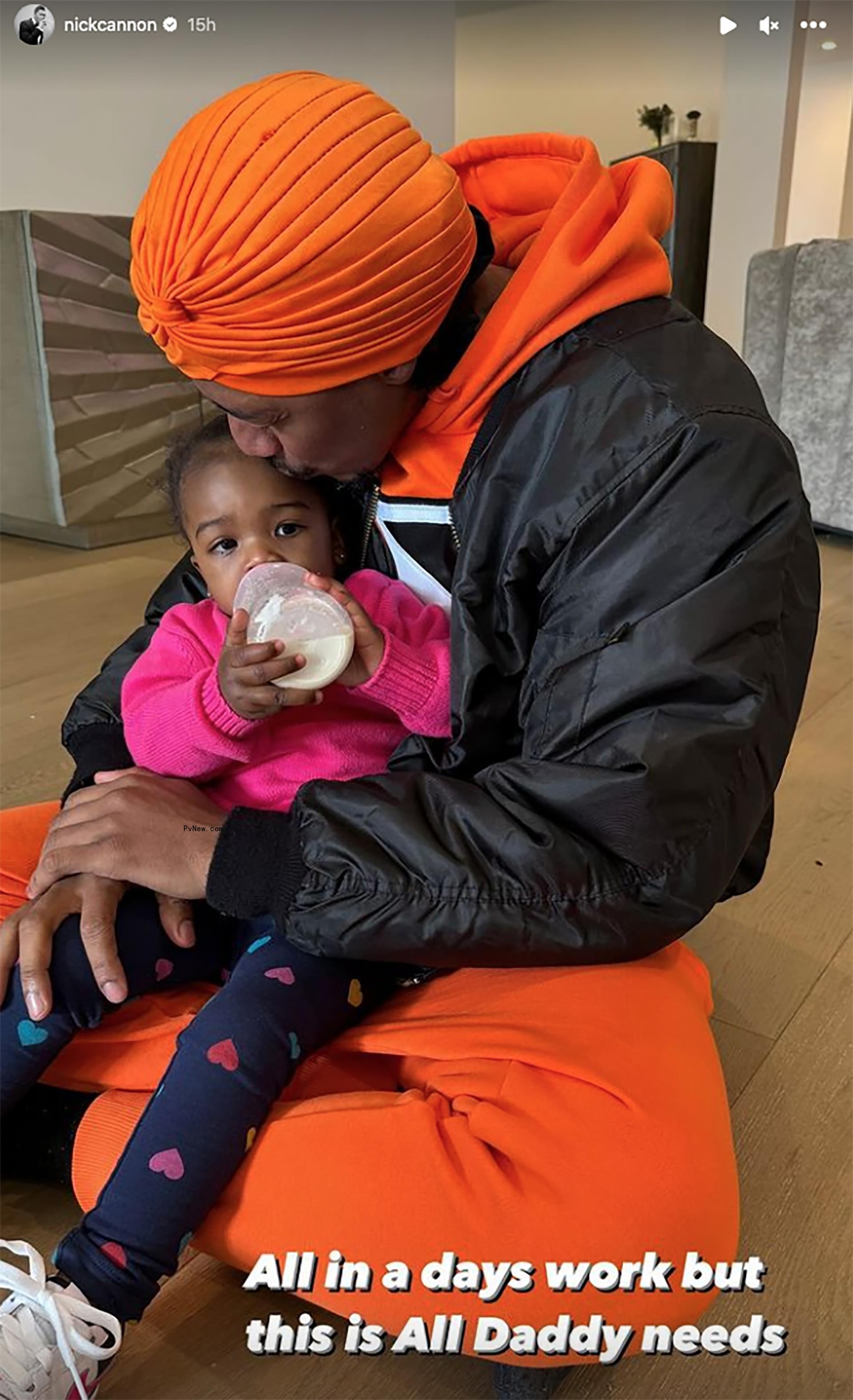 Nick Cannon holding his daughter