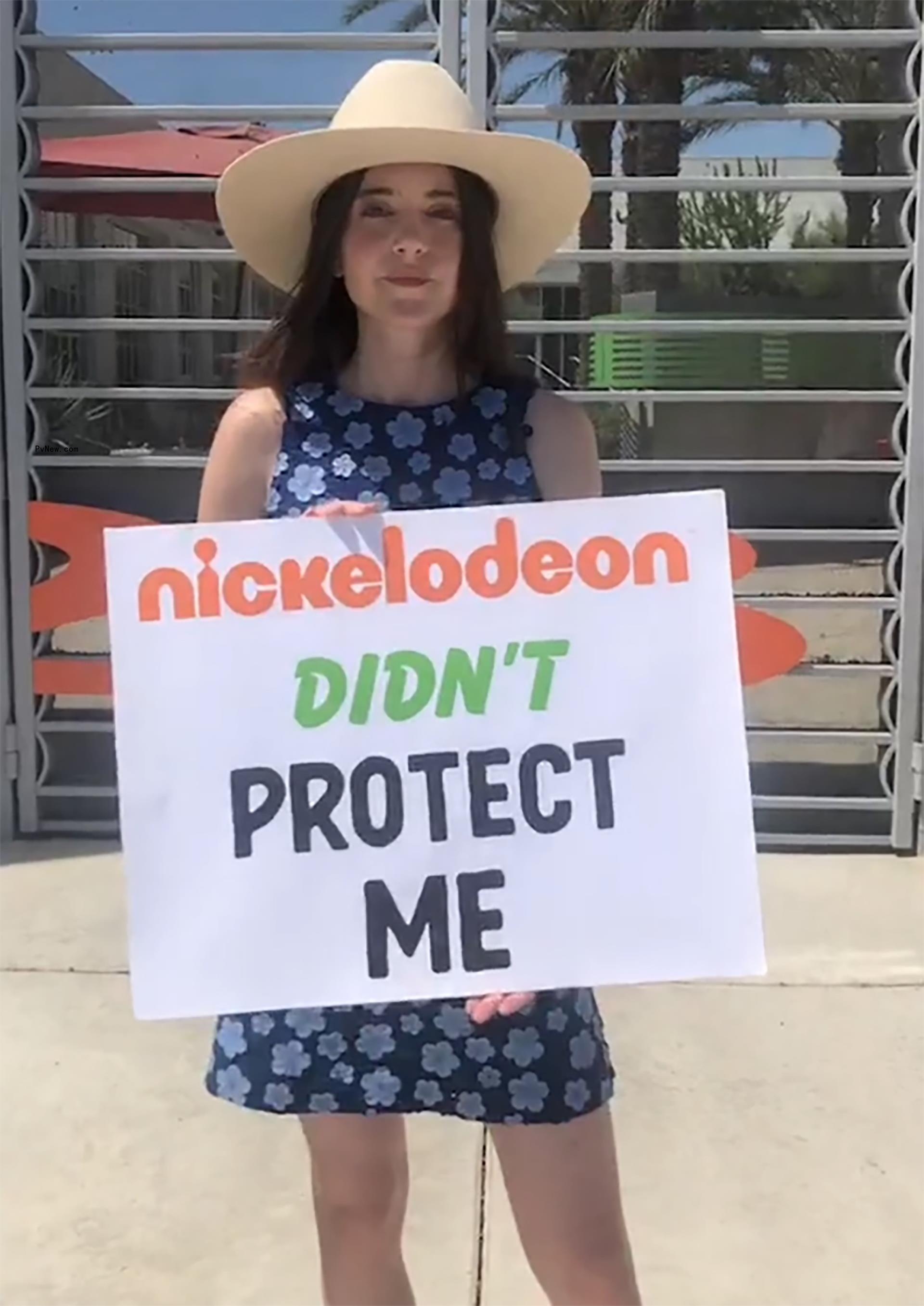 Alexa Nikolas holding a sign that says