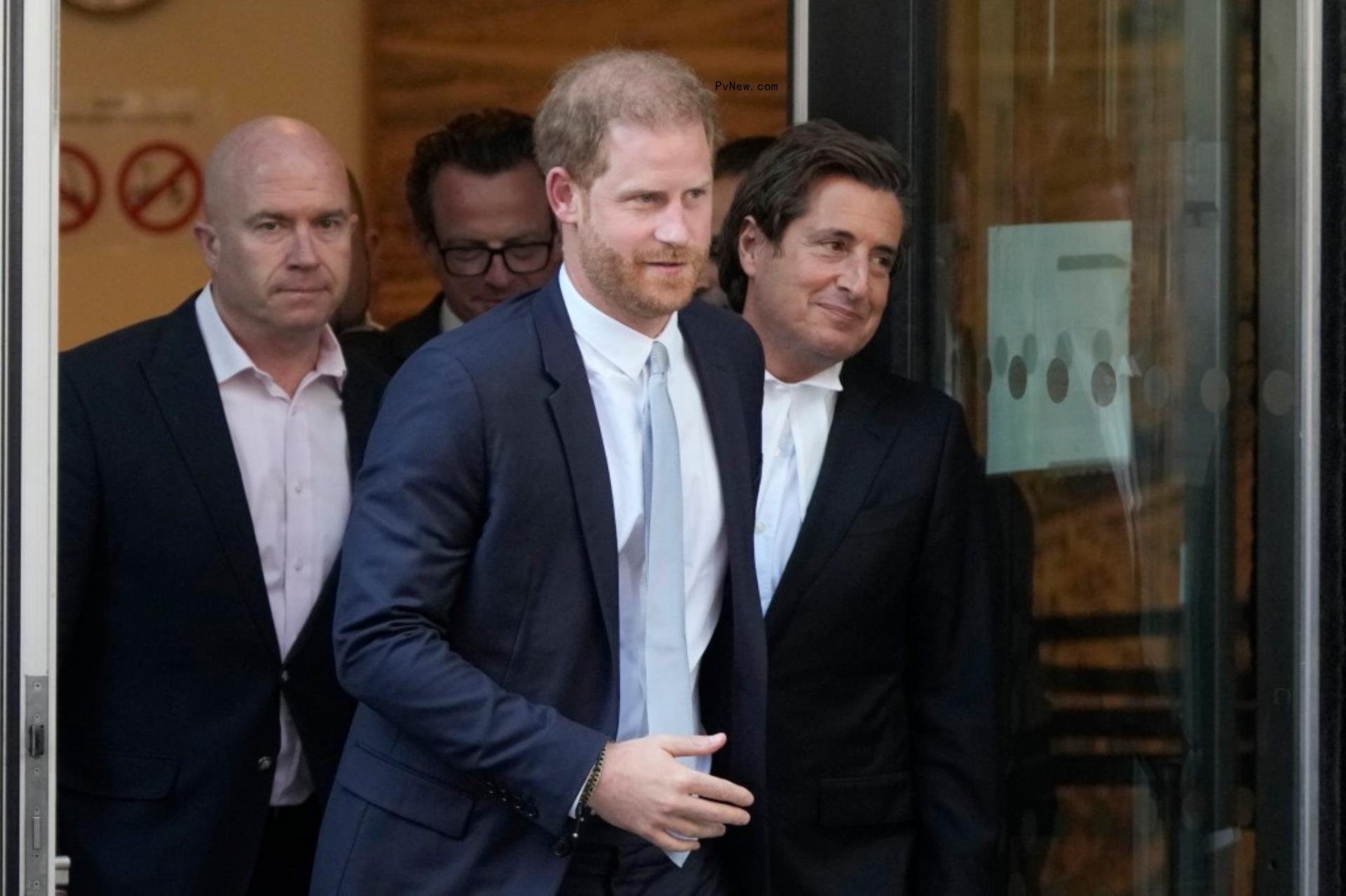 prince harry exiting court with a group of men