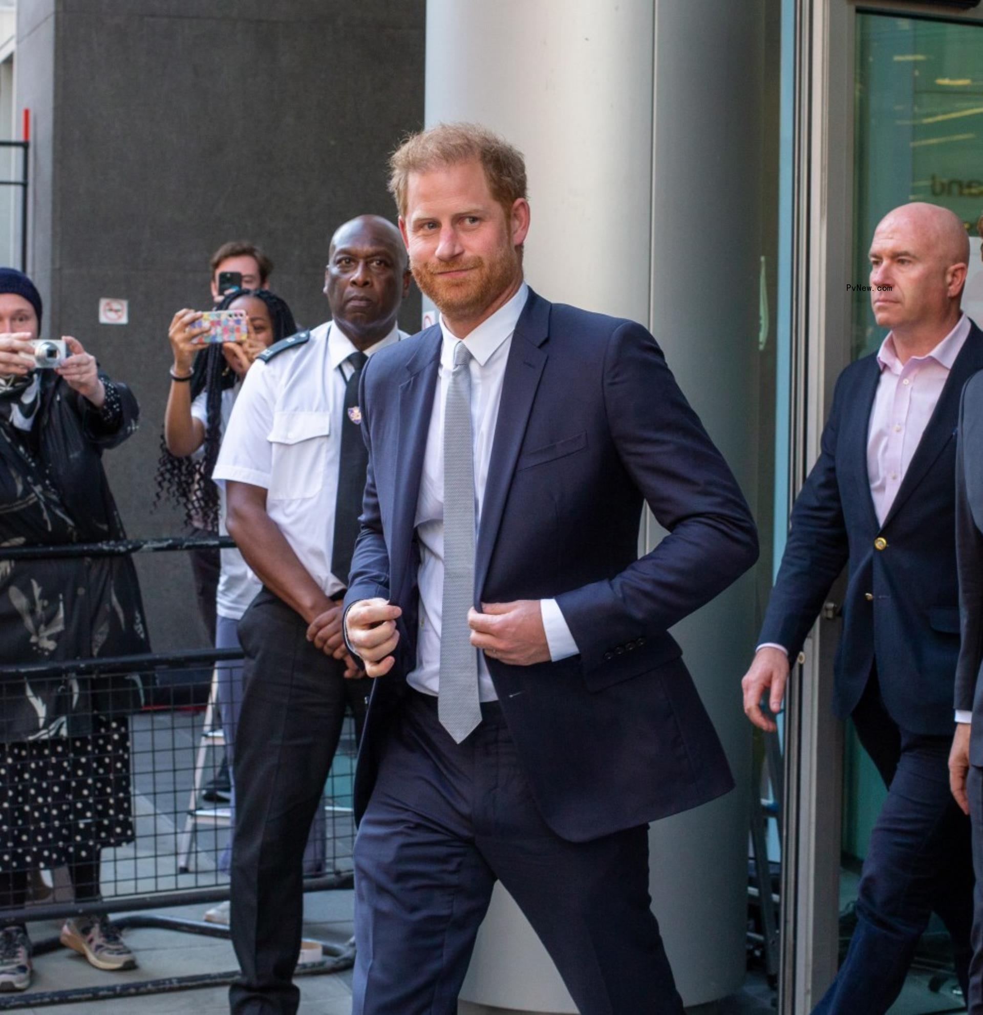 prince harry adjusting his suit while walking