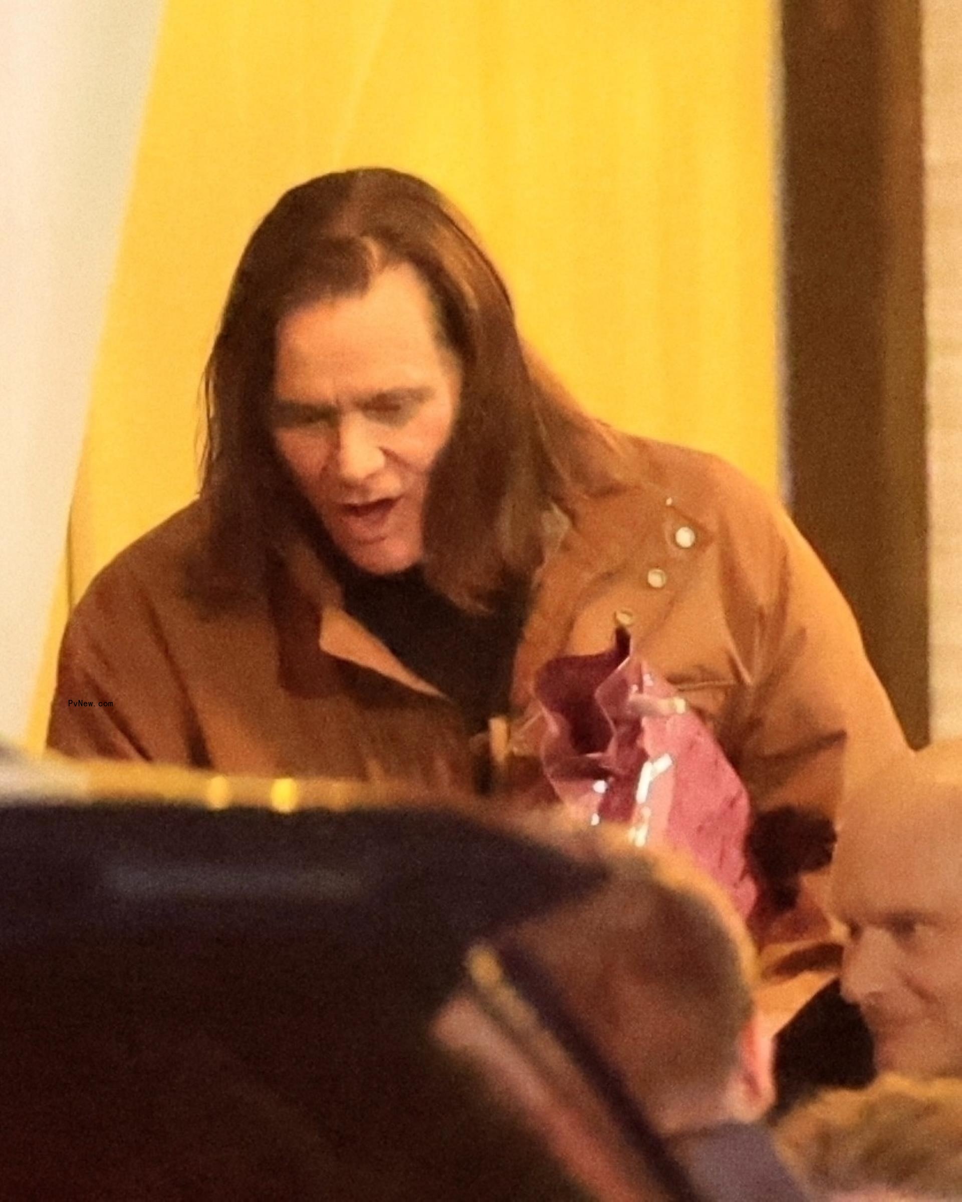 Jim Carrey leaving a restaurant.