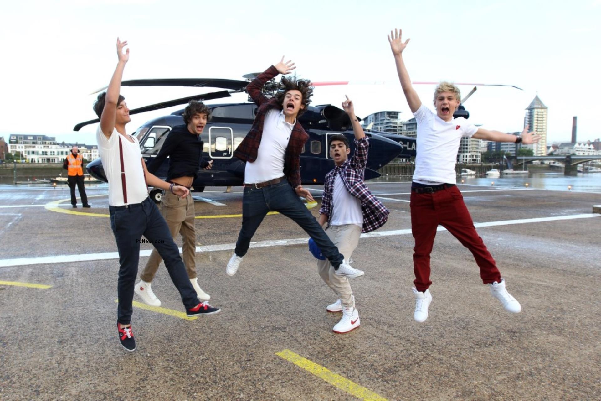 One Direction jumping in the air in 2011.
