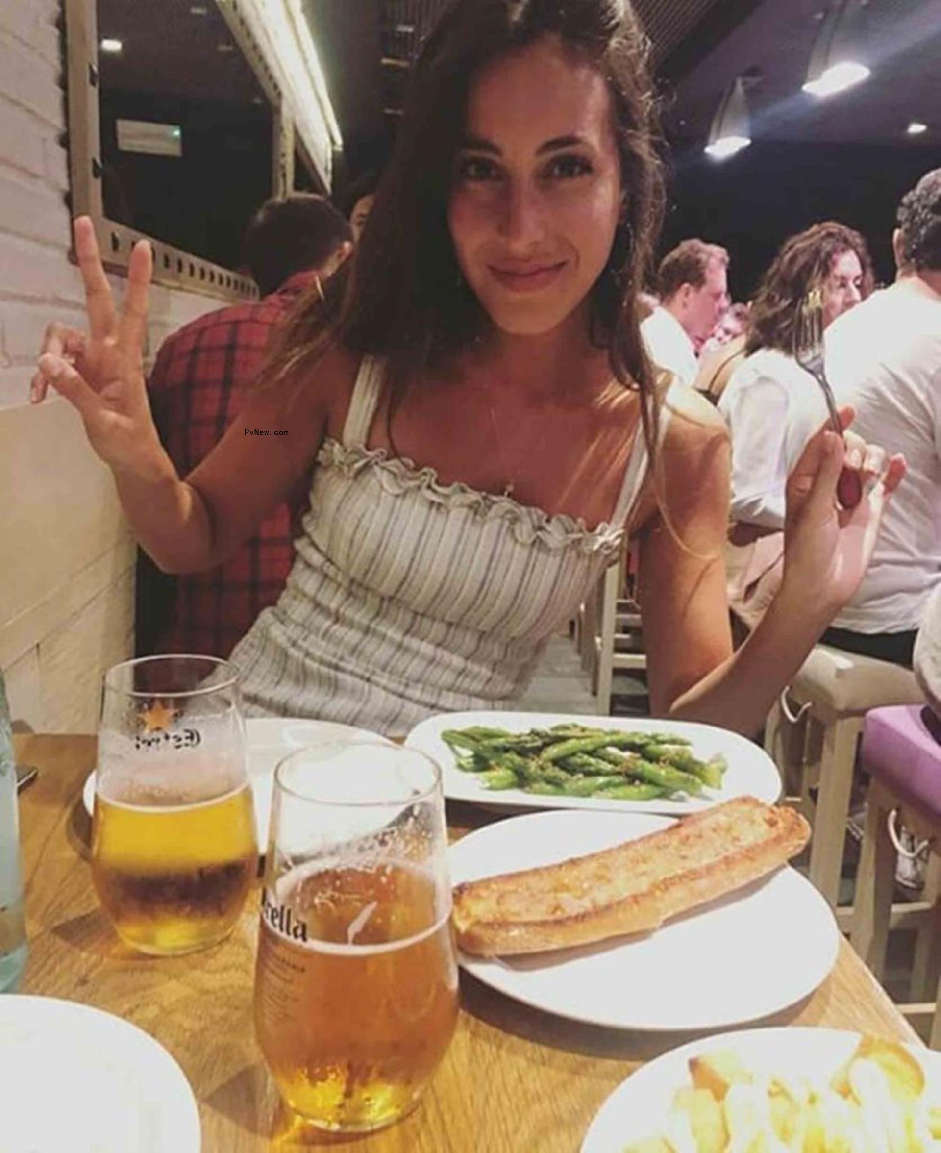 ines de ramon holding up peace signs at a restaurant table that has shishito peppers on it