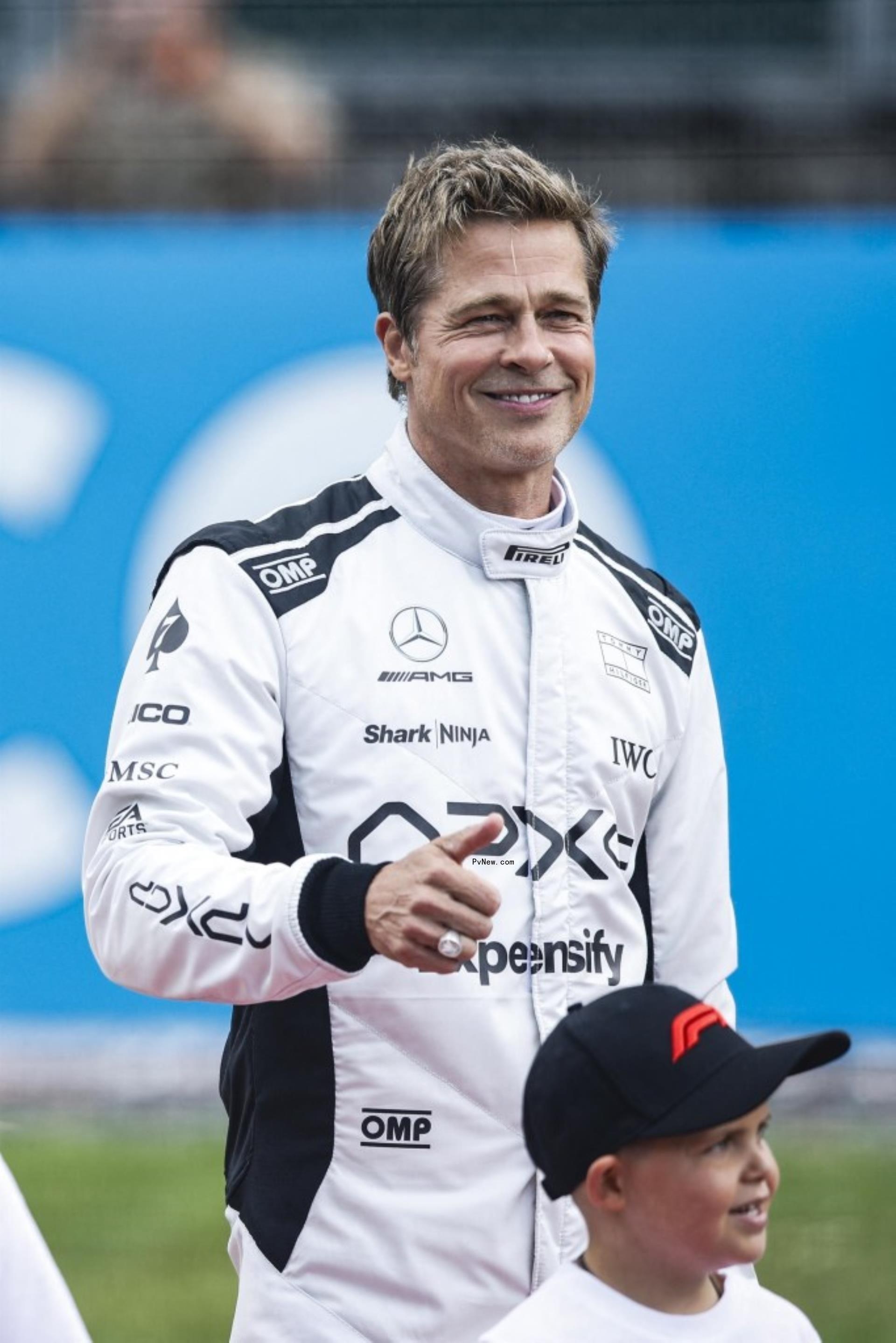 brad pitt in a formula 1 uniform giving a thumbs up