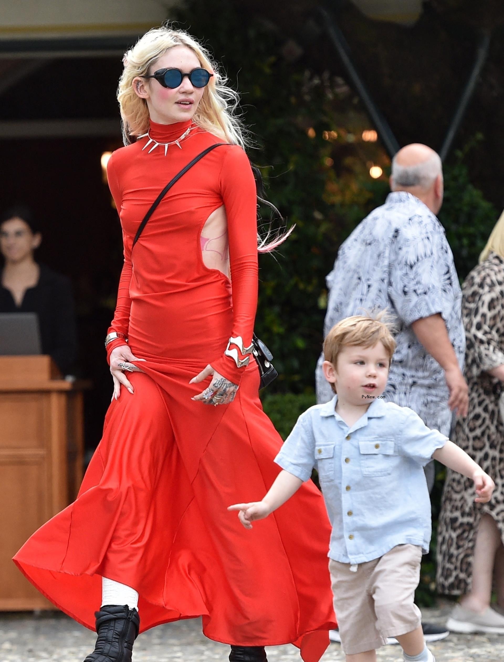 Grimes going for a walk with her son in Italy.