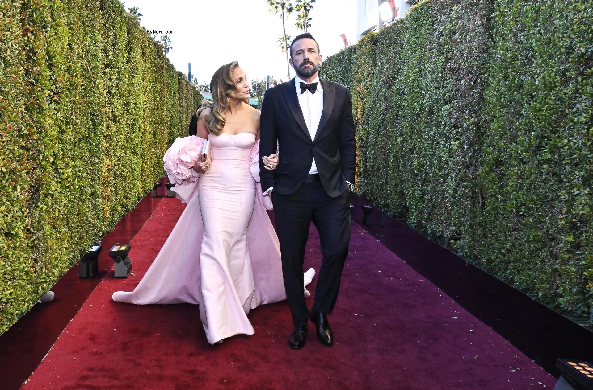 Jennifer Lopez and Ben Affleck walking at the Golden Globes 2024