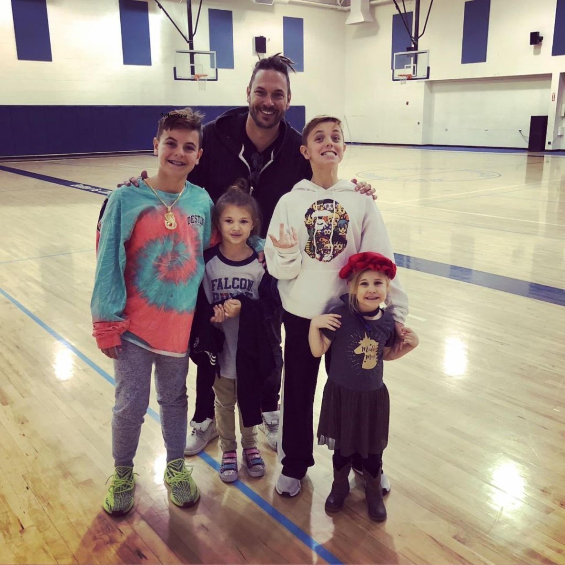 Kevin Federline and four of his children in a school gym.