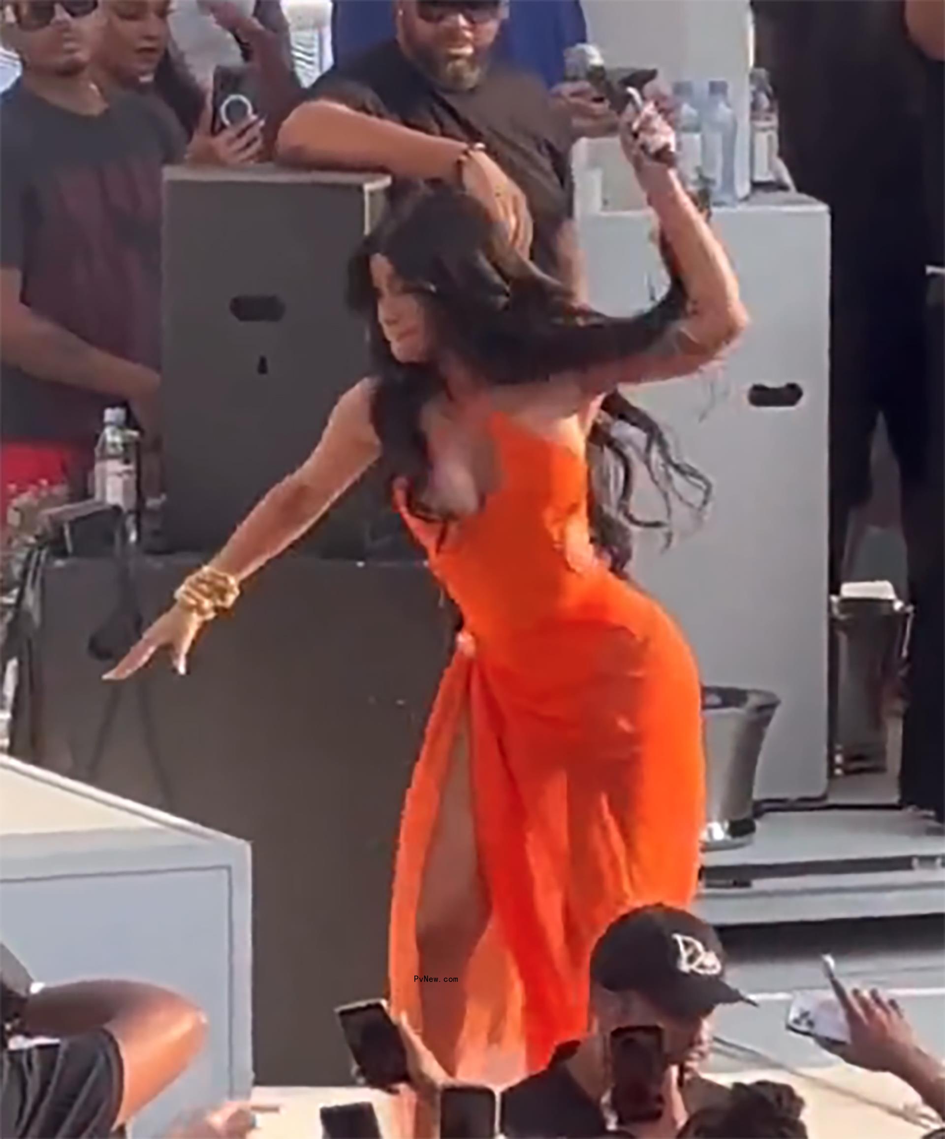 Cardi B throwing microphone on stage.