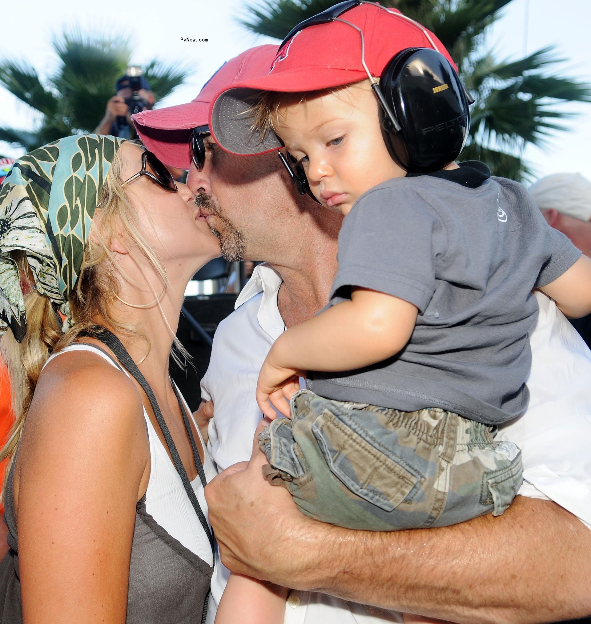 Kevin Costner kisses his wife, Christine Baumgartner, as he holds his son Cayden Costner in 2008.