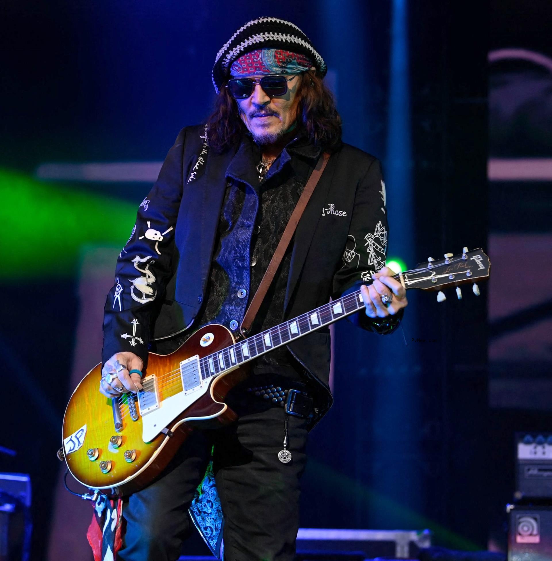 Johnny Depp playing a guitar