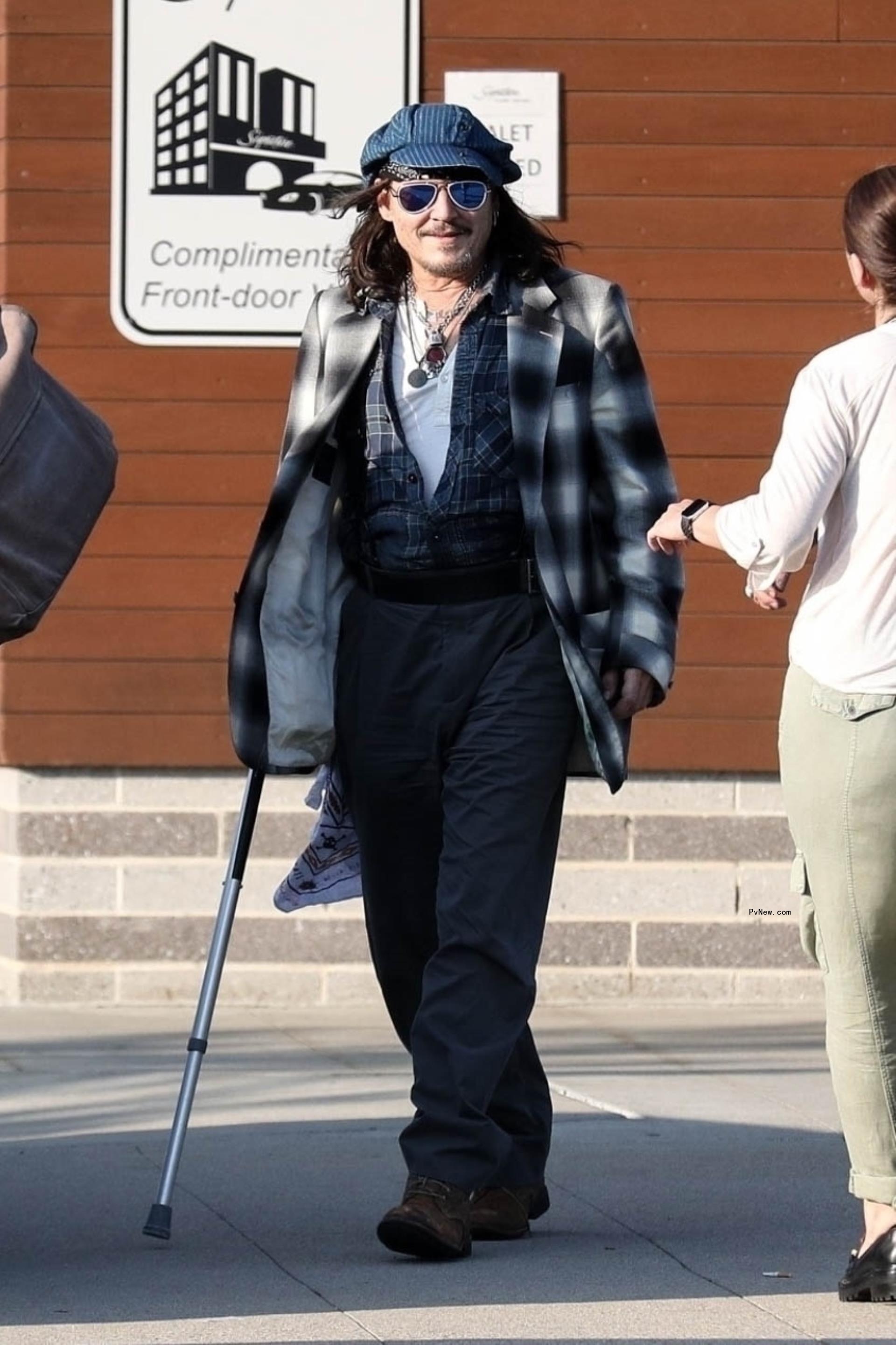 Johnny Depp walking with cane
