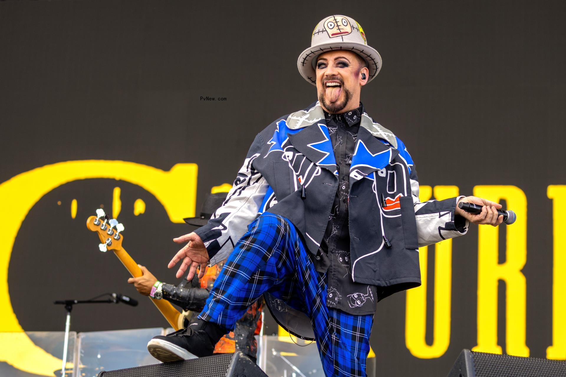 Boy George dancing onstage.