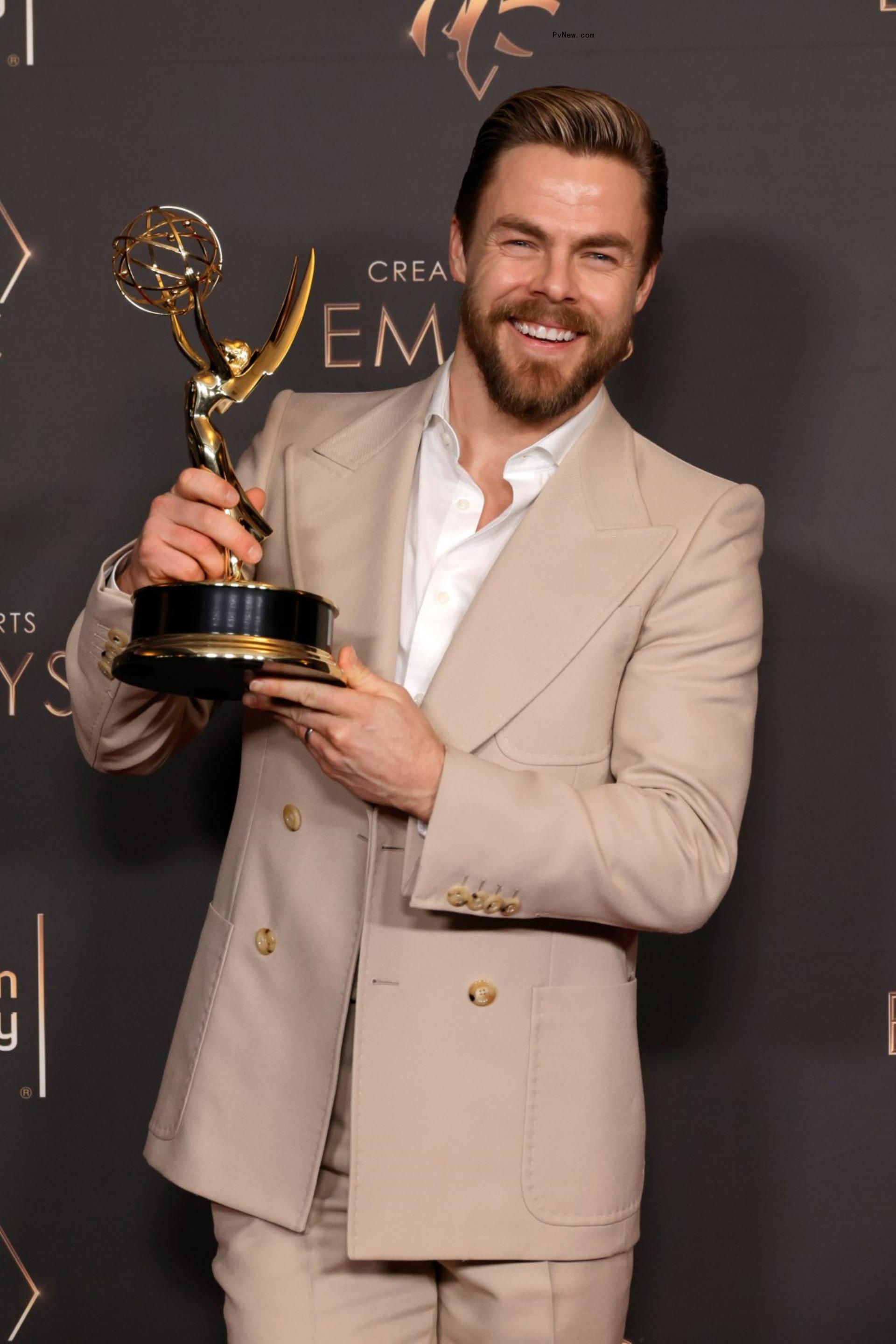 Derek Hough holding an Emmy