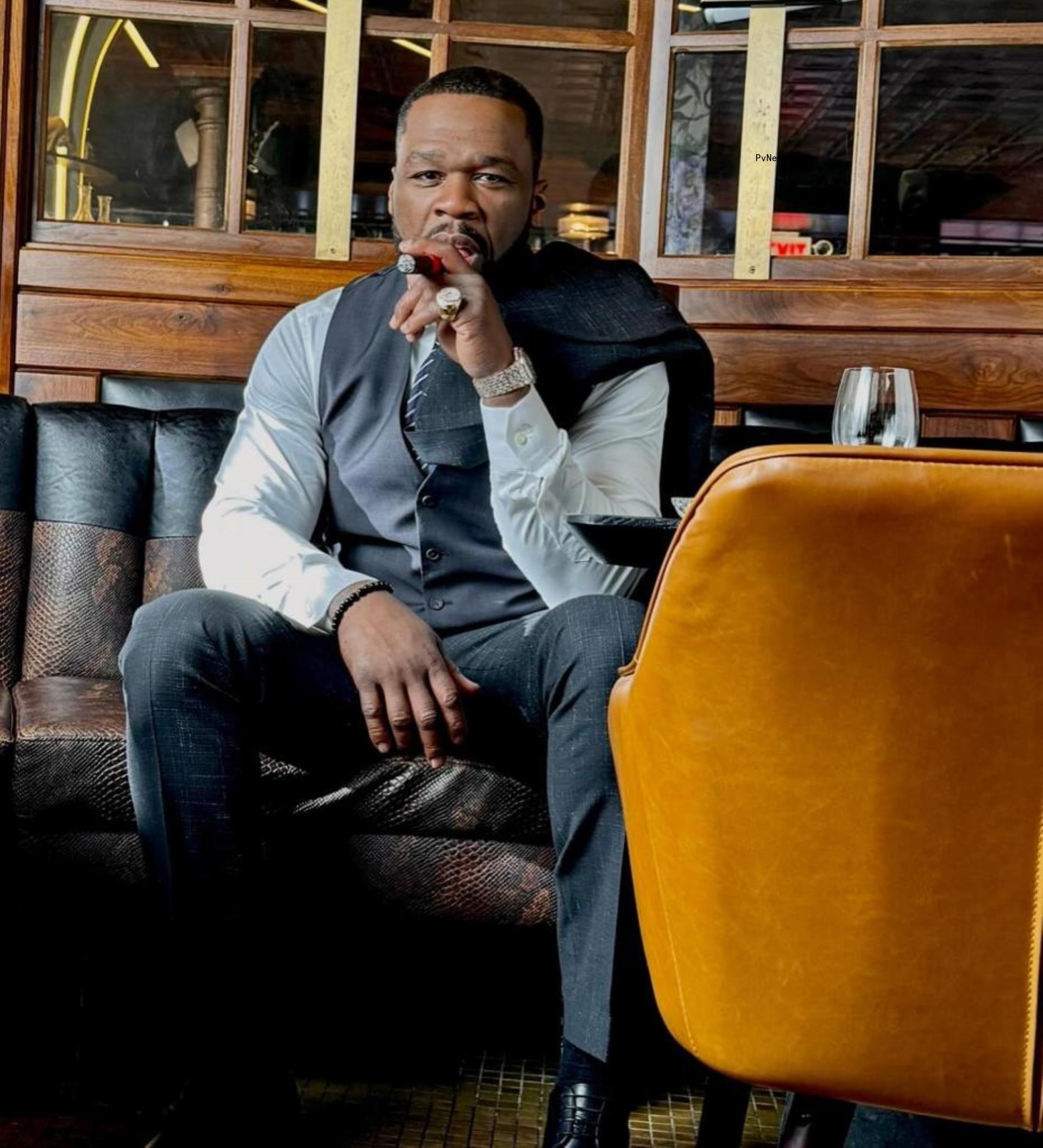 50 Cent holding a cigar.