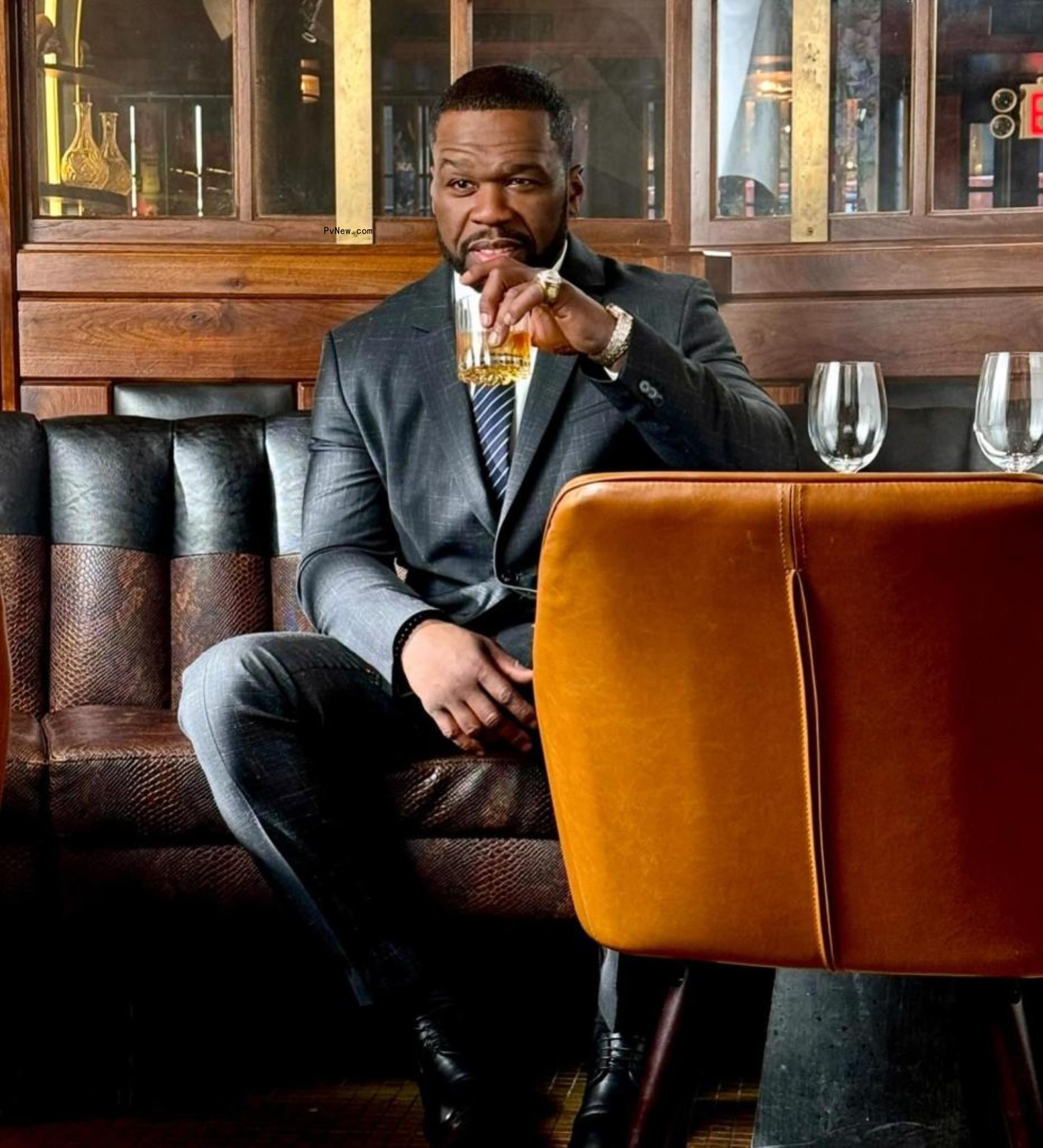 50 Cent holding a drink.