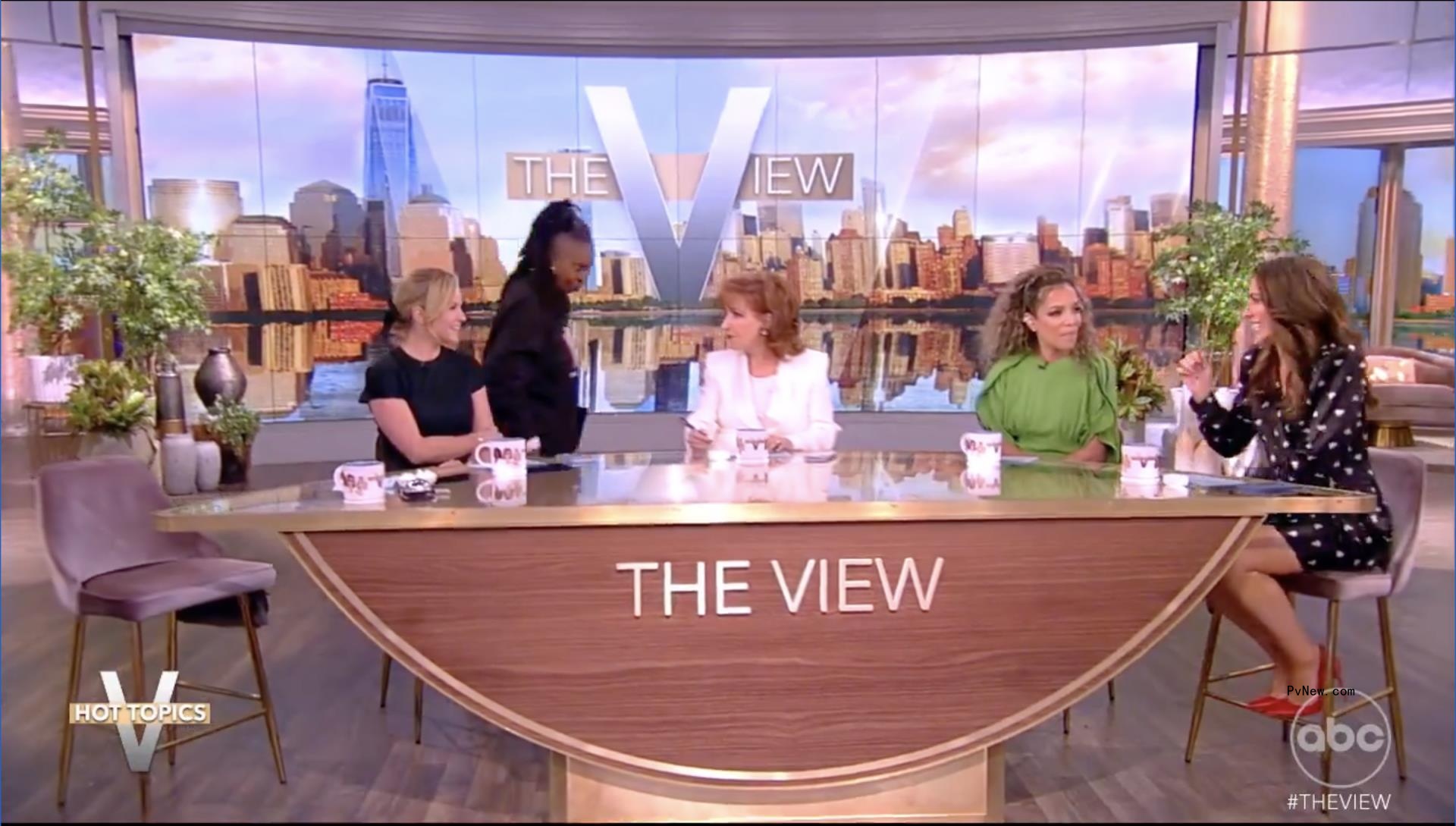 Whoopi Goldberg walking away from the table on 