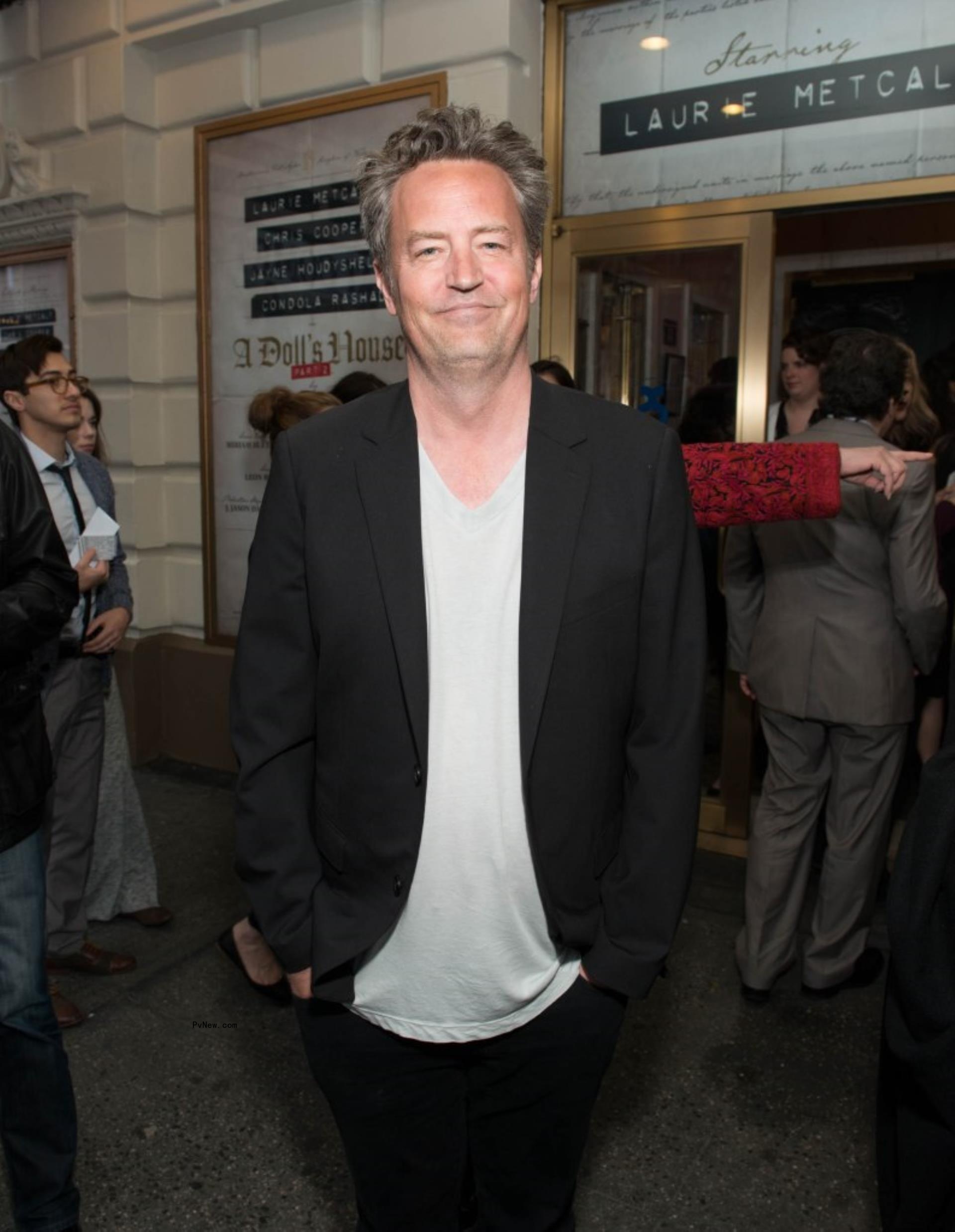 matthew perry standing outside of a broadway theater