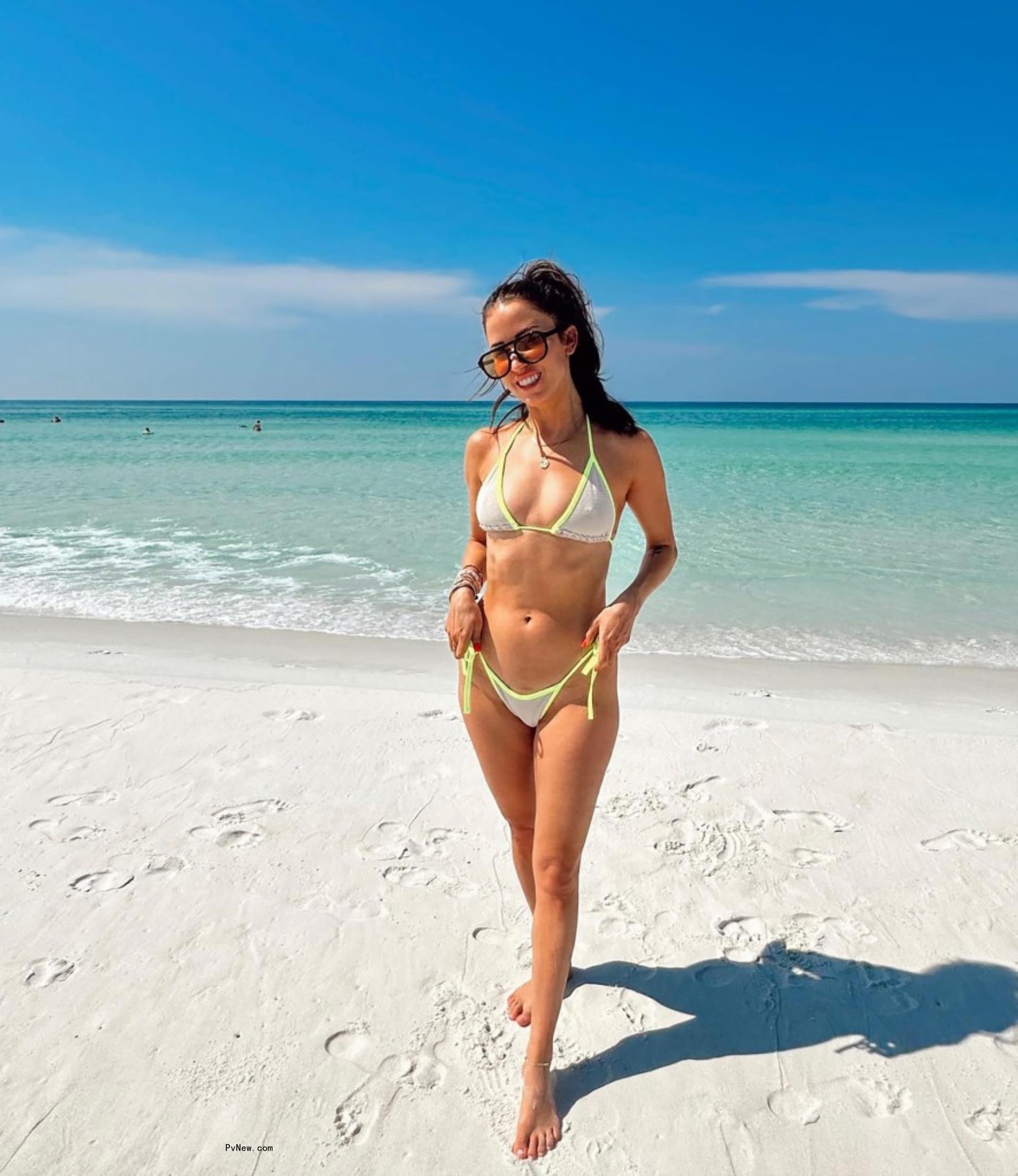 Kaitlyn Bristowe wearing a bikini on a beach without her engagement ring on.