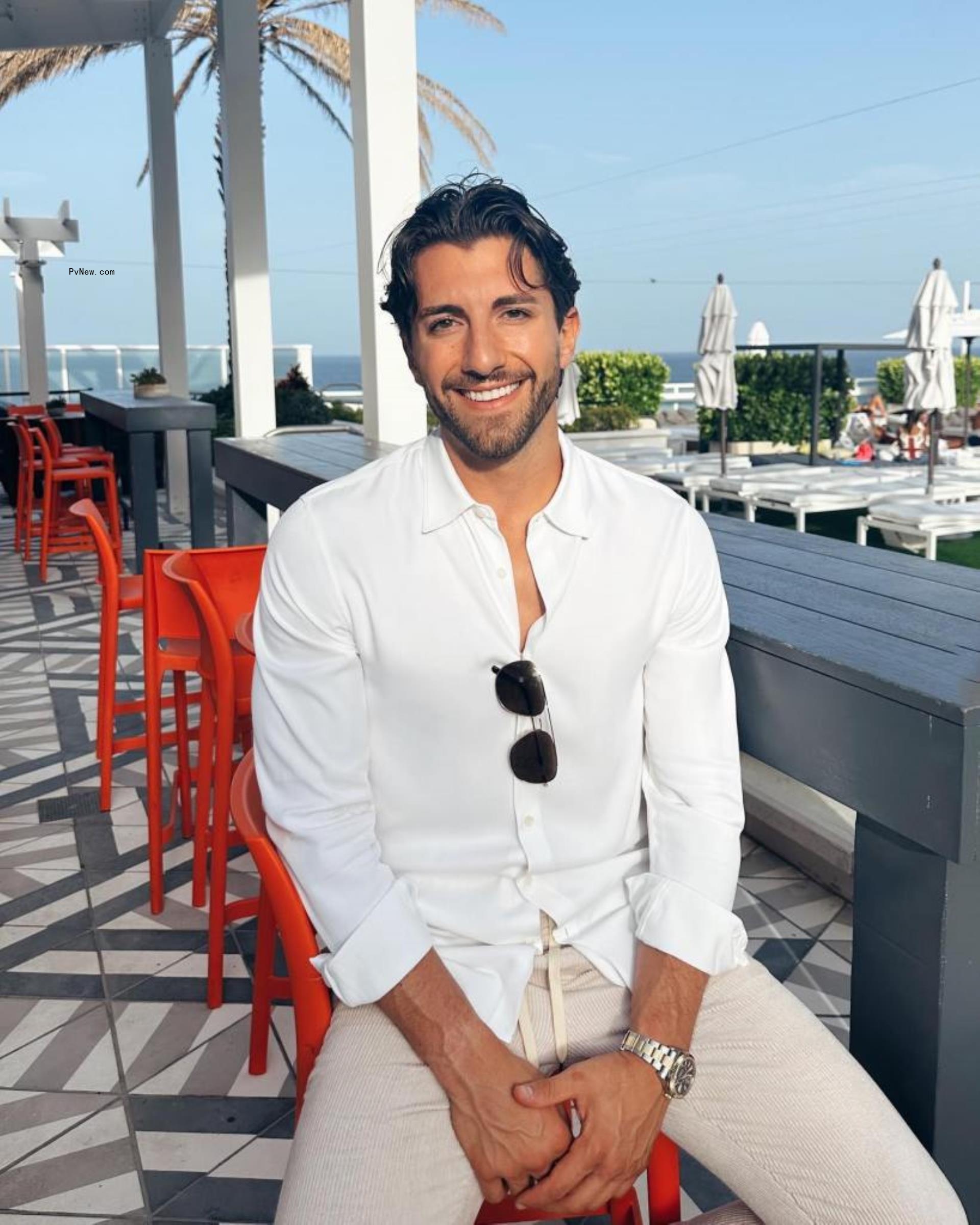 Jason Tartick sitting at a bar outdoors.