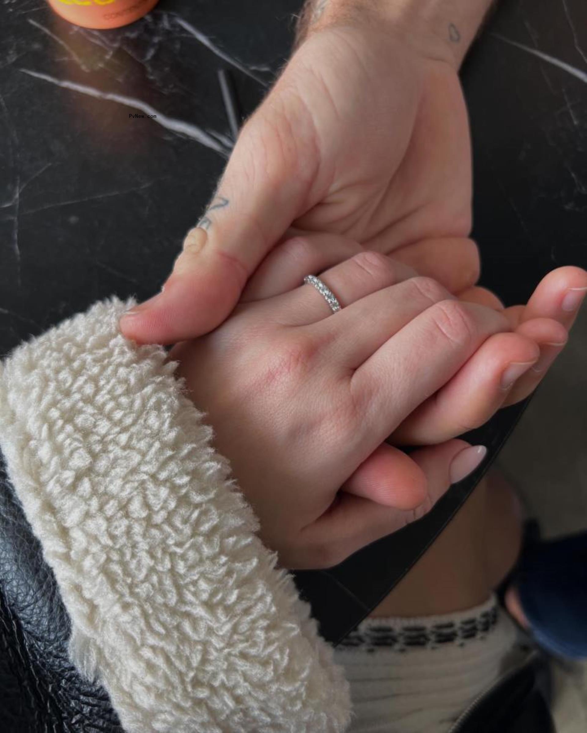 a man's hand holding a woman's hand