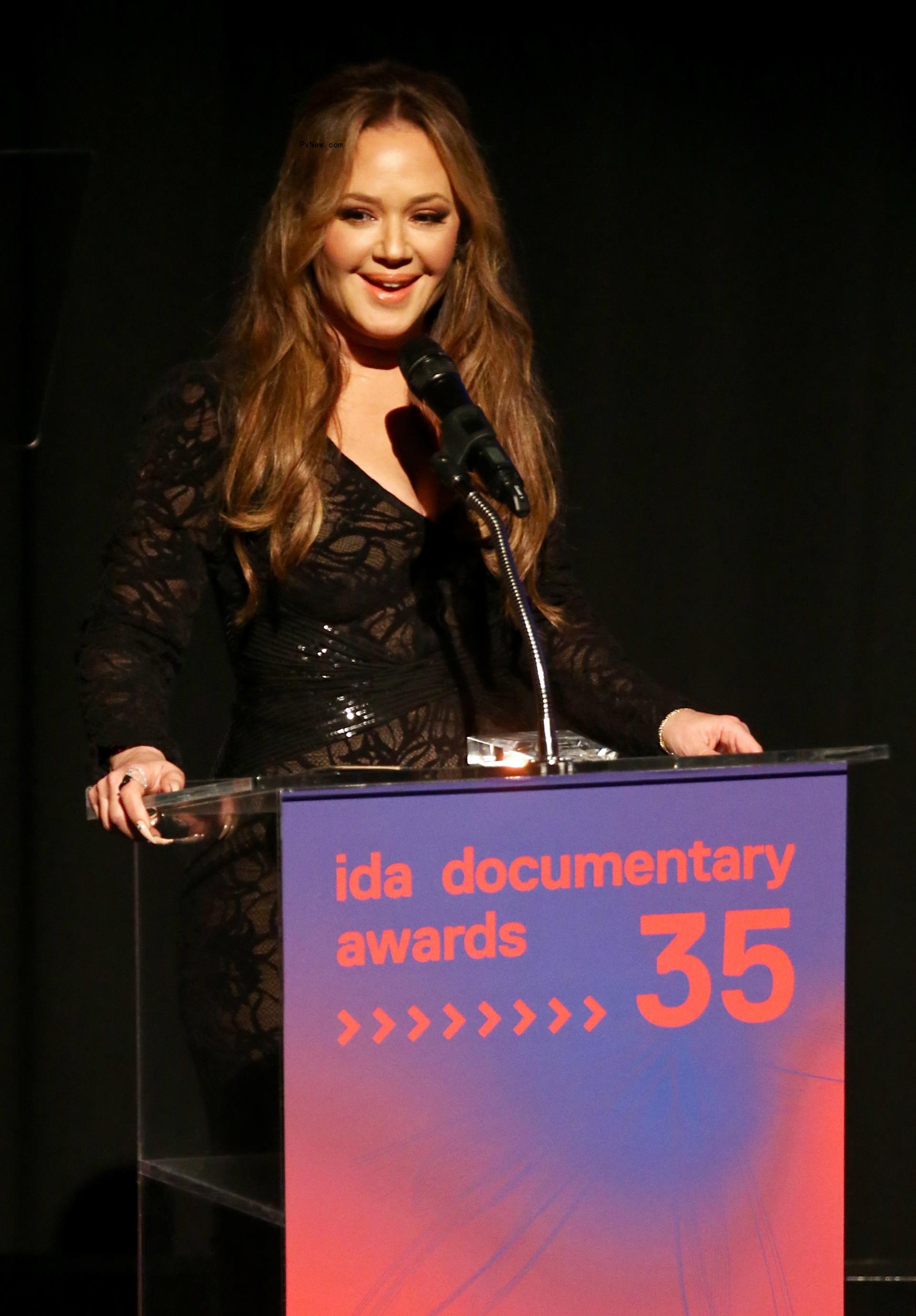 Leah Remini speaking at a podium.