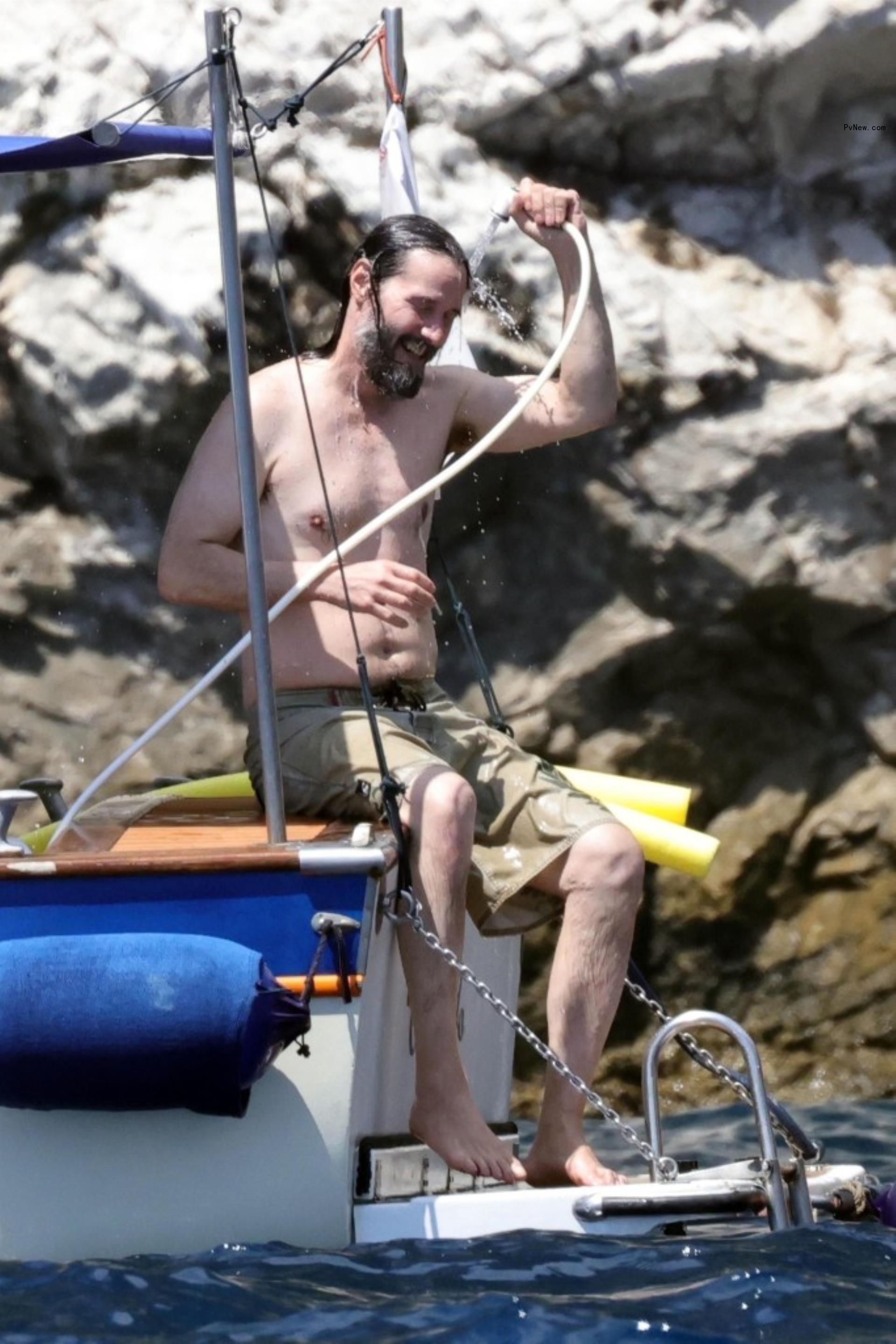shirtless keanu reeves hosing himself off