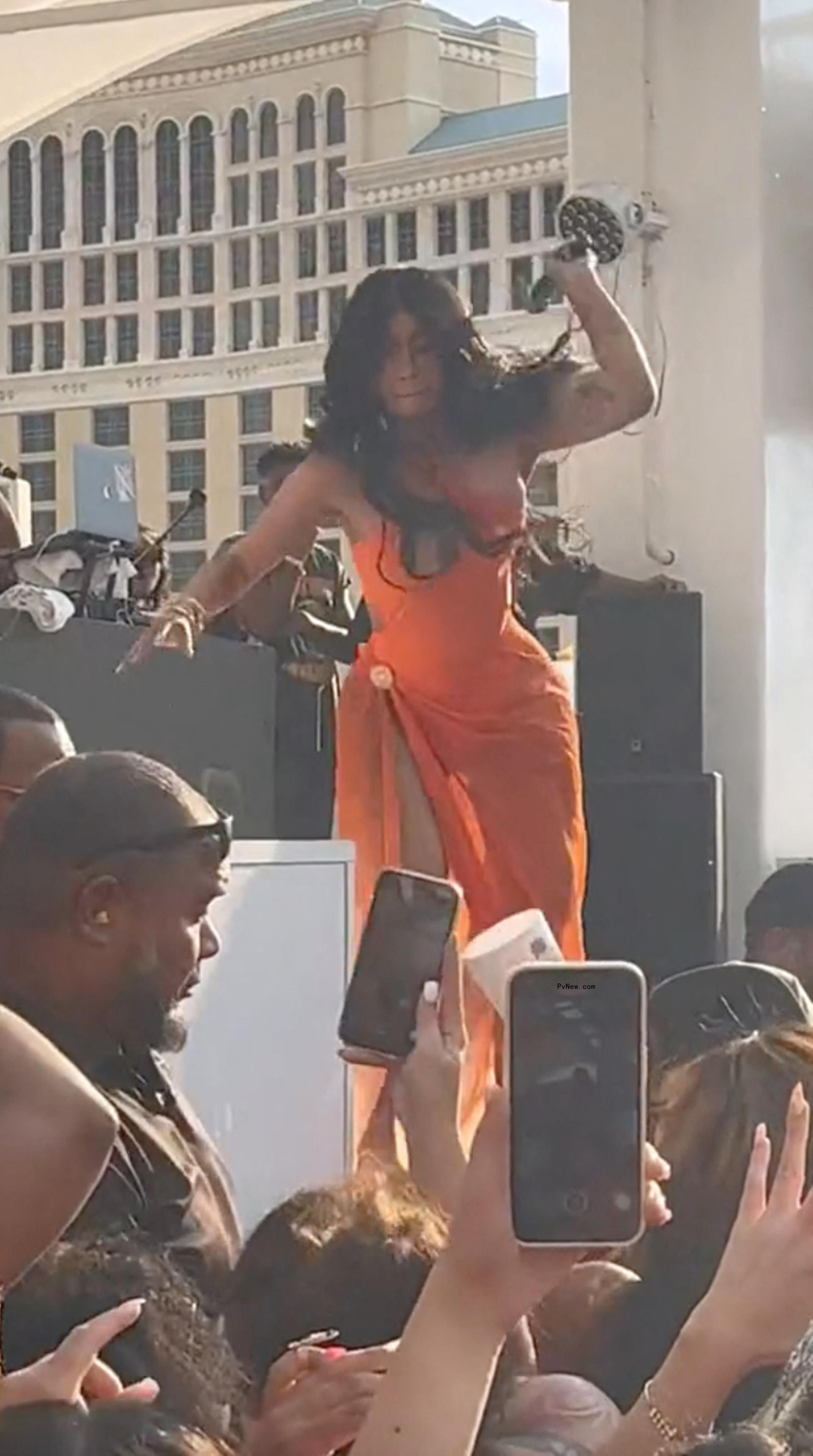 Cardi B throwing a mic at a fan.