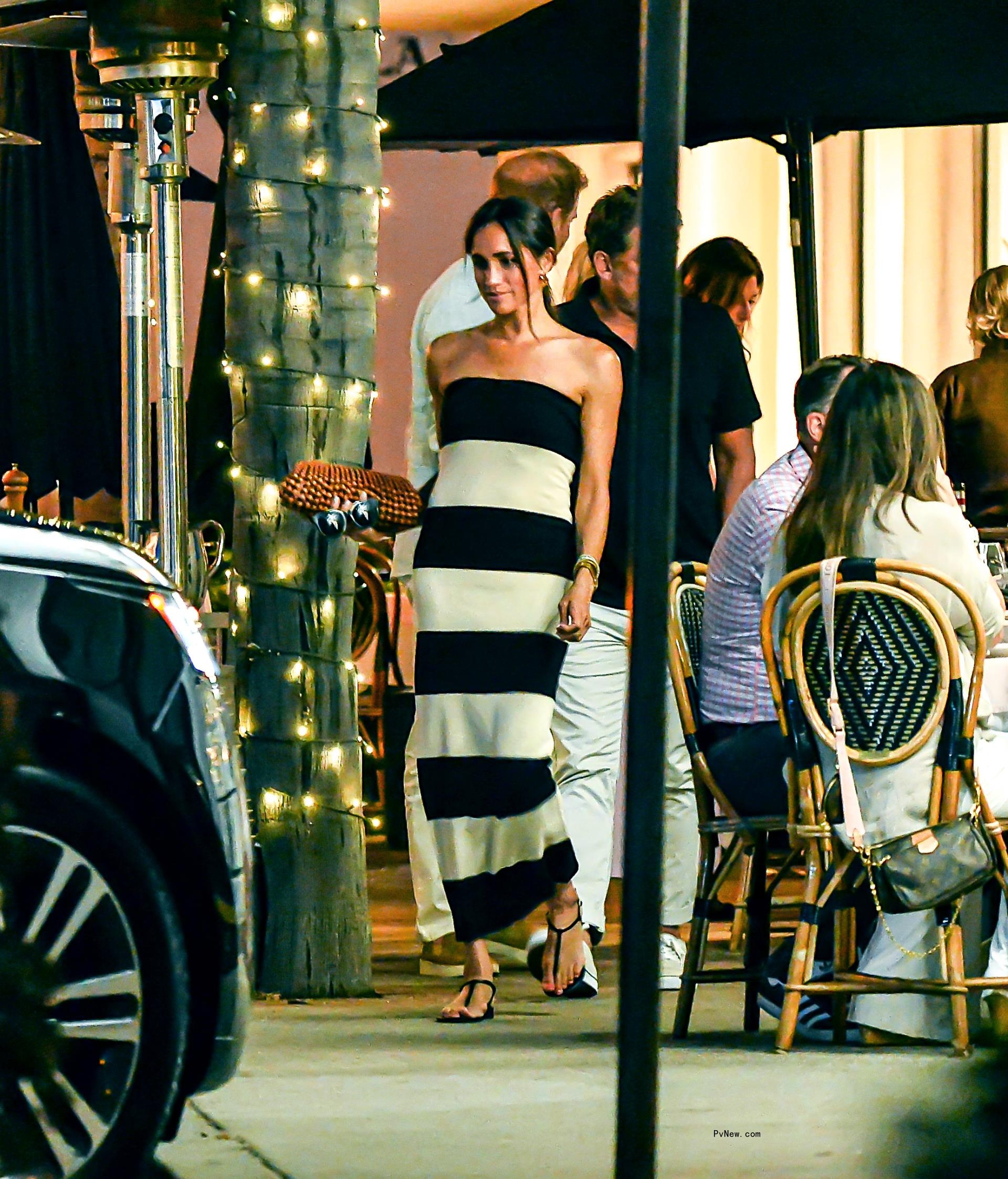 Meghan Markle wearing a black-and-white striped dress