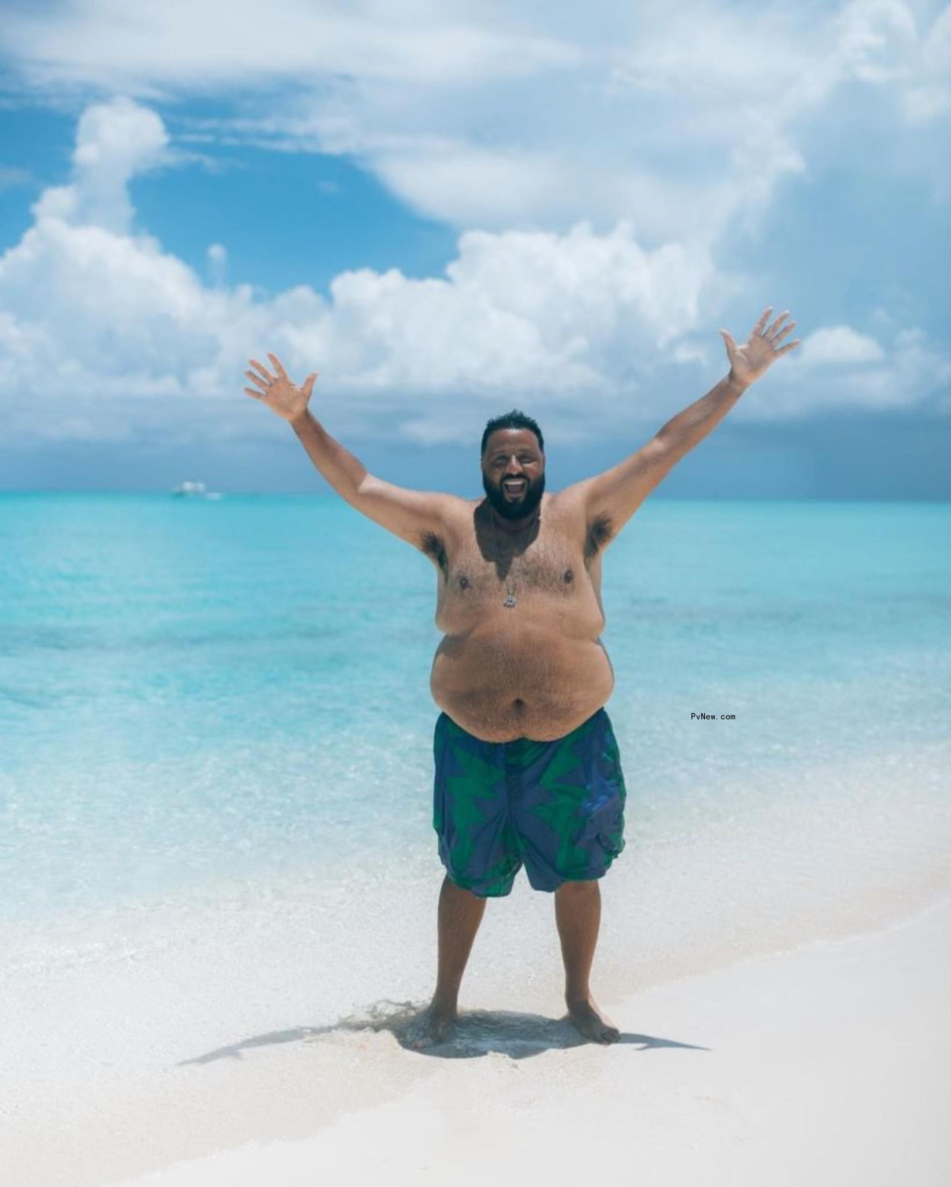 DJ Khaled on the beach topless.