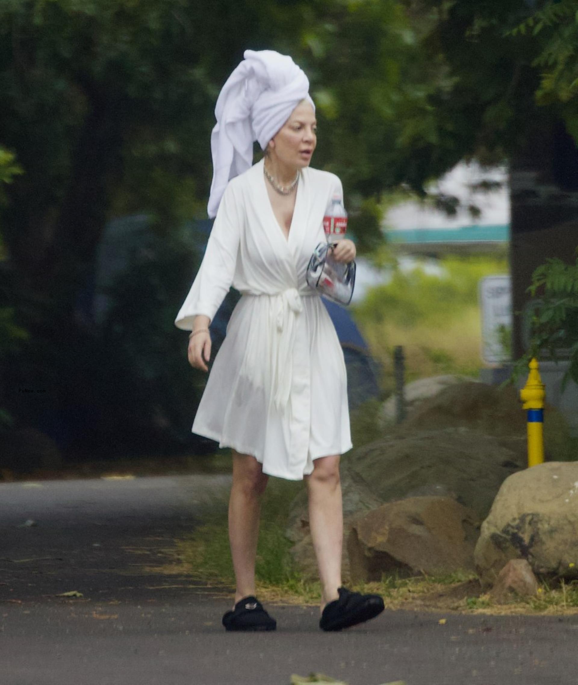 Tori Spelling in a robe outside of her RV. 