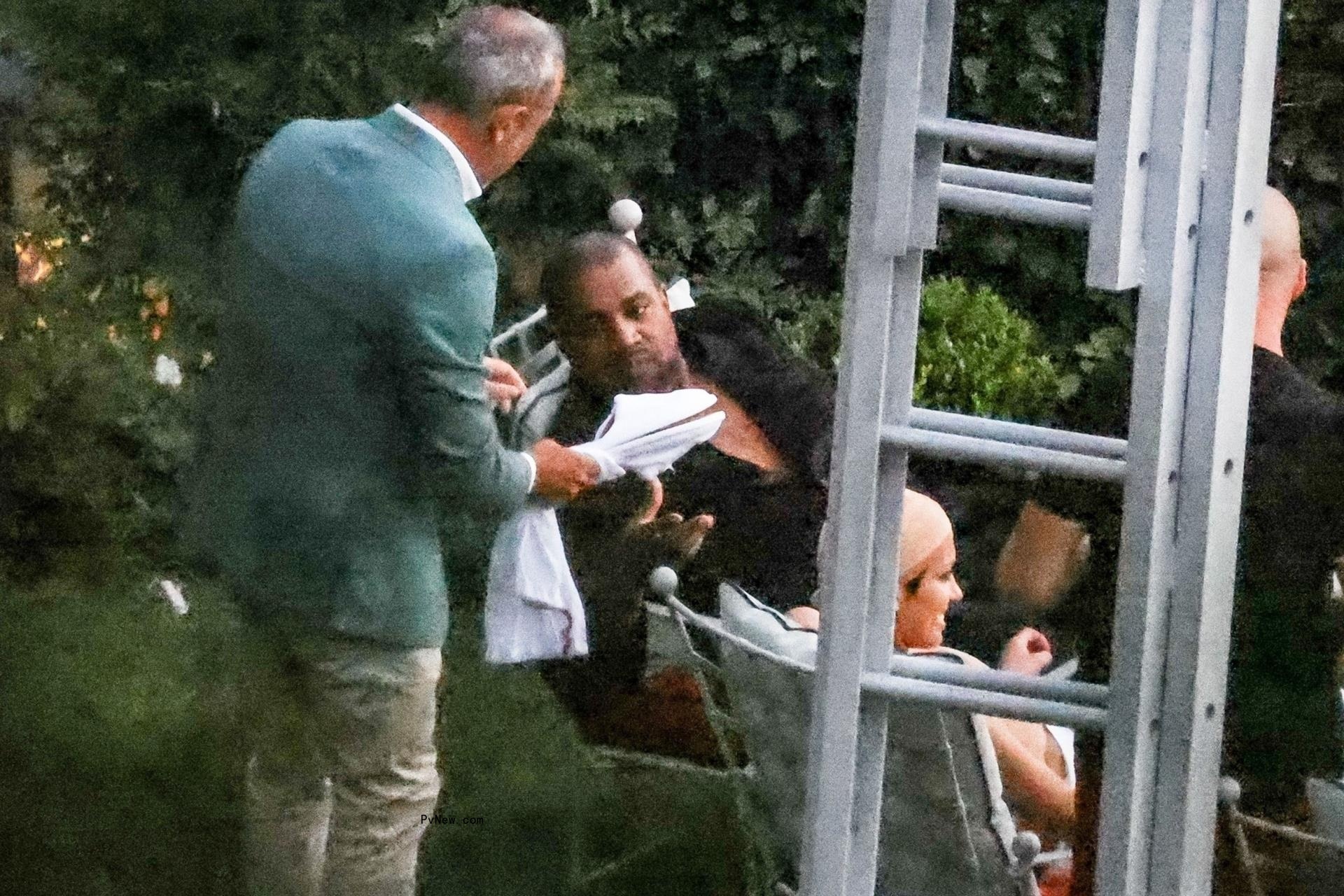 Man offering Kanye West slippers