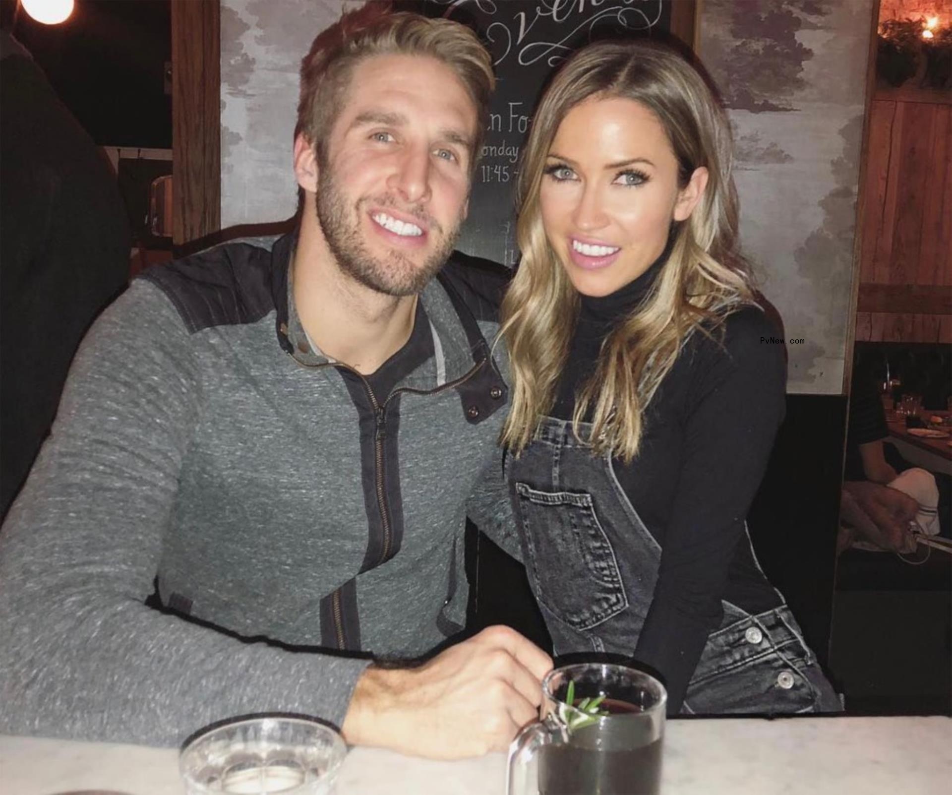Shawn Booth and Kaitlyn Bristowe smiling together at a restaurant table.