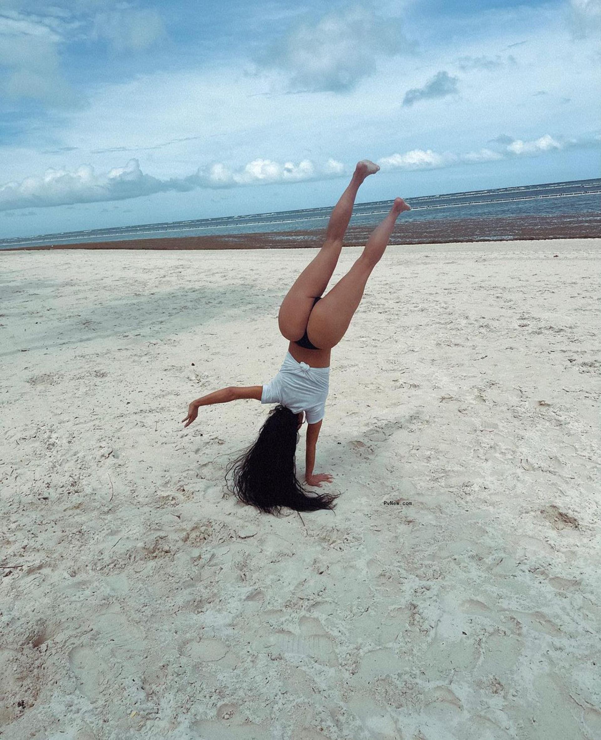 Kim Kardashian doing a cartwheel in a thong