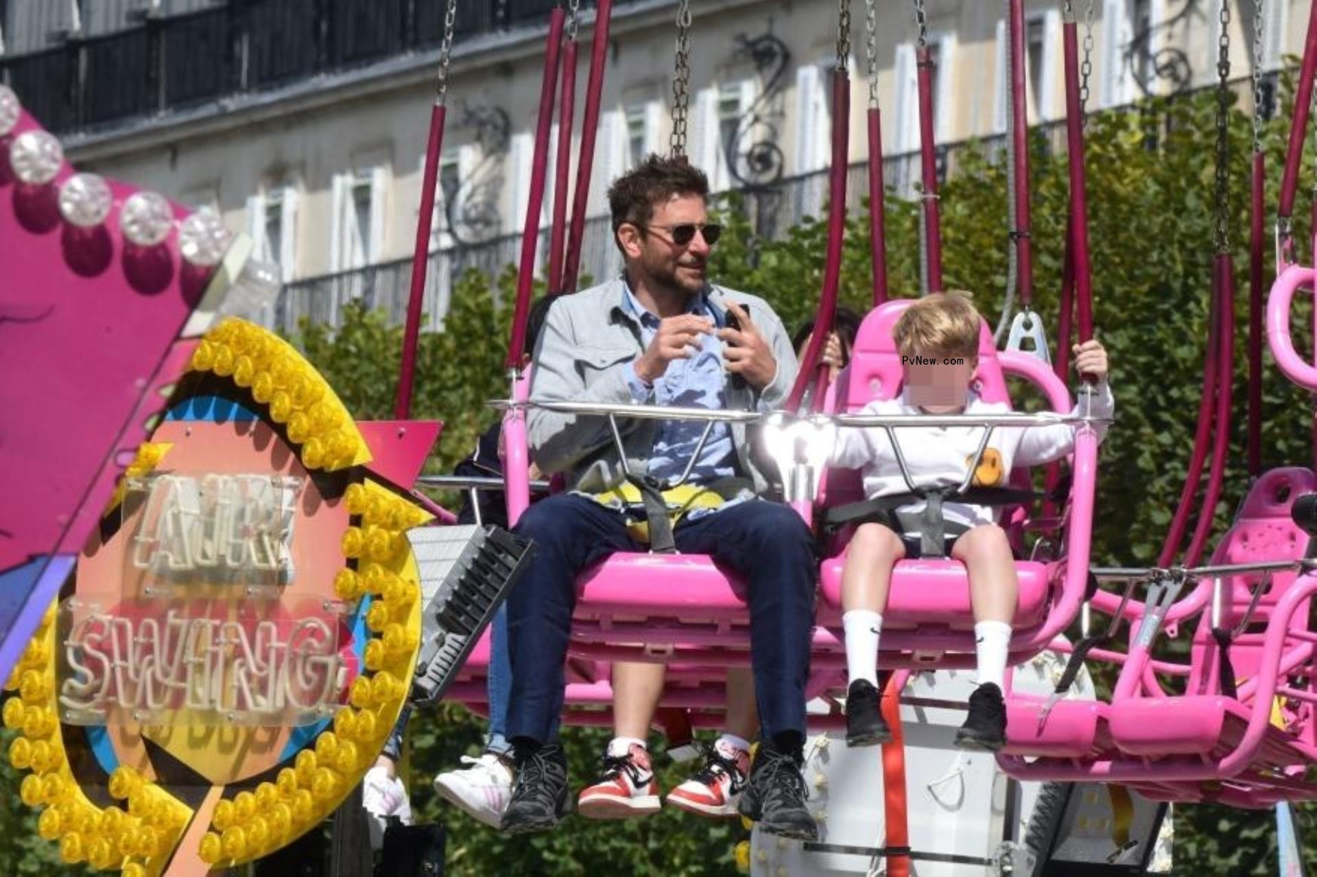 Bradley Cooper riding swings at the fair
